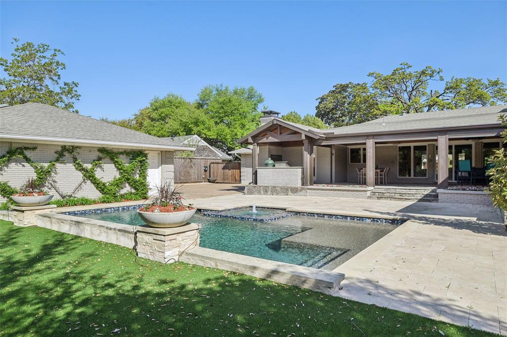 *Back on the market due to no fault of the property.* Stunning, thoughtfully designed open-concept home situated on a 120x150 foot lot in one of Dallas’ most sought-after neighborhoods. Built in 1956, this single-story home offers exceptional curb appeal, multiple entertaining spaces, and over 500 sqft of covered outdoor living. Off the entry, you’ll find a formal living rm and an inviting family rm featuring vaulted ceilings, custom built-ins, and a gas fireplace. These spaces flow seamlessly into the formal dining rm and a beautifully appointed chef’s kitchen. The kitchen is equipped with an expansive island, 2 dishwashers, built-in refrigerator, beverage refrigerator, double ovens, microwave, and an impressive walk-in pantry area with built-ins and a full-size wine refrigerator. An adjoining breakfast rm completes the space. Adjacent to the kitchen is a spacious game rm with built-ins and a full bath—ideal for entertaining or flexible living. The private primary suite is tucked at the rear of the home, offering serene views of the sparkling pool, plus a generous WI closet. The luxurious primary bath features high-end marble finishes, dual vanities, a jetted tub, and a sep shower. 2 secondary bedrooms, both with WI closets, share a Jack-and-Jill bath, while a 3rd bedroom enjoys access to a full, hall bath. A large utility rm, complete with built-ins and a sink, rounds out the interior of this home. The backyard is an entertainer’s dream, showcasing multiple seating areas, motorized screens, built-in grill, Green Egg cooker, beverage refrigerator, TV, and a wood-burning fireplace. The outdoor living space overlooks the resort-style pool with spa and water feature, along with a generously sized turfed yard. Addl highlights: Sonos speakers in the kitchen, primary bedroom, and patio; oversized 24x27 garage with workspace and storage; a gated driveway; and exterior security cameras. Ideally located near Preston Royal shopping & dining with quick access to the Tollway.