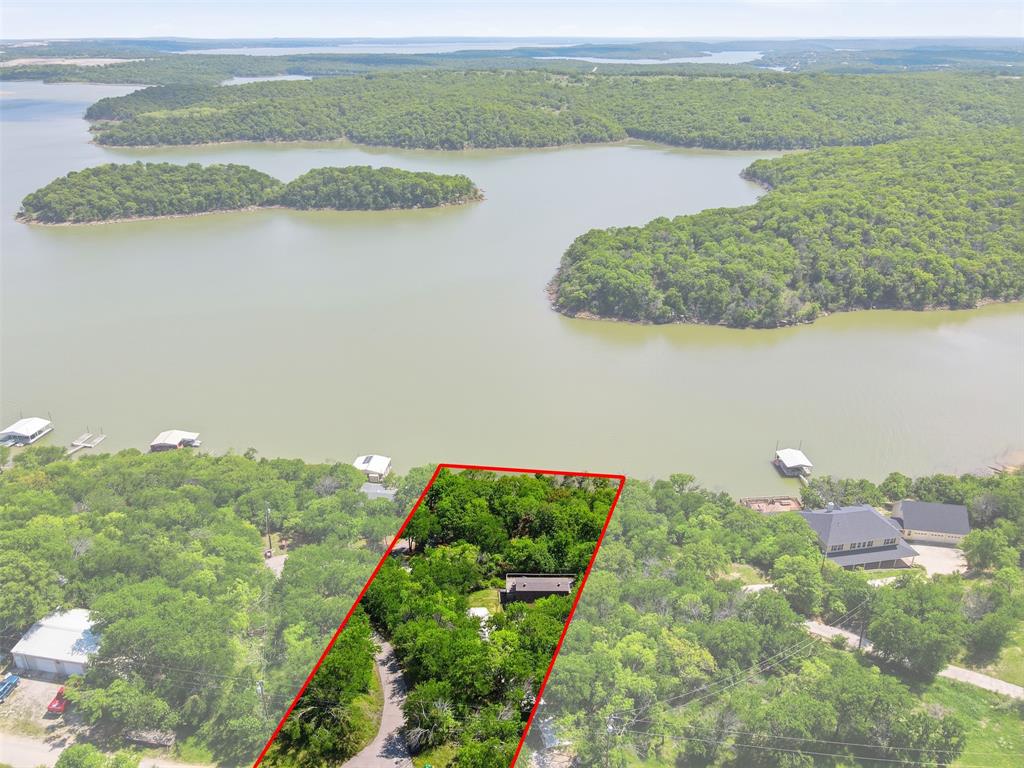 PRICE ADJUSTMENT!  Investor special on Lake Bridgeport! Situated on a treed, nearly half-acre lot with direct lake access, this property offers exceptional potential for renovation, resale, or short-term rental income.  The existing cottage is in need of updates, making it an ideal value add opportunity for investors looking to maximize returns. Property features include a wraparound covered porch and a private dock, highly desirable amenities for vacationers and weekend renters.  With its prime lakefront location and strong demand for waterfront properties, this is a rare chance to transform a fixer upper into a high performing income producing asset. Plenty of room to enhance, expand, or rebuild to capture full market value.  Bring your vision and unlock the potential this Lake Bridgeport property has to offer!