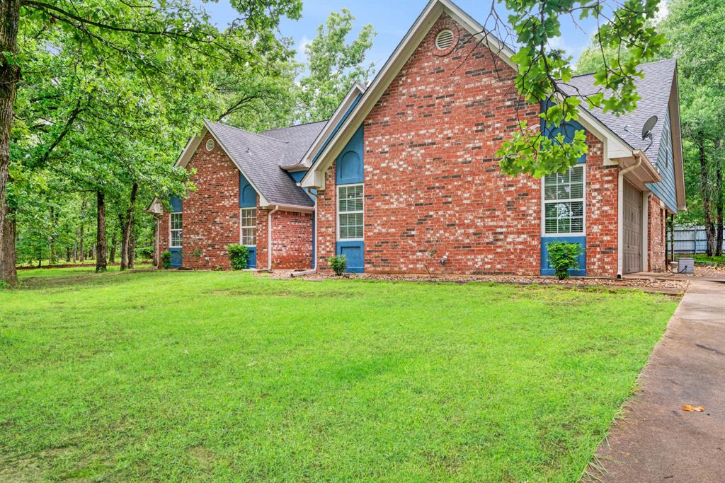 Surrounded by mature trees on a peaceful country setting, this spacious home offers the perfect blend of comfort, privacy and functionality.  The impressive living room features soaring ceilings, built in shelving, floor to ceiling stone fireplace and an open loft overlooking the main living area.

The kitchen offers abundant cabinetry, generous counter space and views of the backyard, making it ideal for everyday living and entertaining.  The oversized primary suite provides plenty of room for a sitting area or home office, while the spa-like primary bath features a large walk-in shower, soaking tub, dual vanities and three walk-in closets.

Step outside and enjoy the beautiful tree-shaded property with plenty of space to relax and unwind.  A standout feature is the separate shop with living quarters, offering endless possibilities for guests, a home business or multigenerational living.

If you're looking for a country living with room to spread out, this unique property is one you won't want to miss!