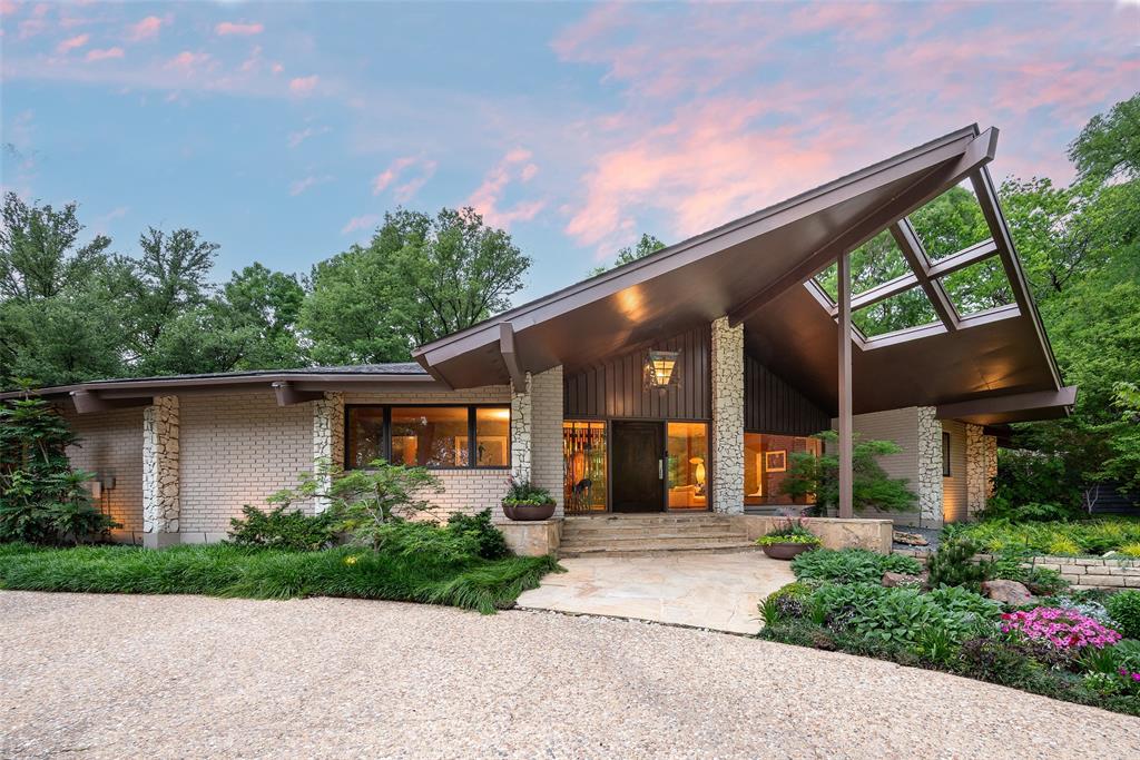 Just steps from White Rock Lake—literally across the street—this extraordinary gated estate offers a rare opportunity to live immersed in one of Dallas’ most coveted natural settings. Set on a 0.75-acre lot in the sought-after Cloisters neighborhood of Lakewood, the property is framed by towering specimen trees and Zen-like landscape by acclaimed architect Naud Burnett creating a serene, private retreat of exceptional beauty and calm.This soft-contemporary residence is defined by intentional sightlines and architectural harmony. The single-level layout with proportionate ceiling heights include three bedroom suites, one currently serving as a private office. A second living area functions as a den but could convert to a fourth bedroom suite if desired. Rich Wenge wood cabinetry evokes yacht-level craftsmanship, while gracefully curved hardwood floors guide you through a light-filled interior. The gourmet kitchen is equipped with Miele, Wolf, and Sub-Zero appliances.The secluded primary suite is a true sanctuary with a spa-inspired bath featuring dual vanities, a jetted soaking tub, a separate glass-enclosed shower, and two spacious walk-in closets.Enhancing the estate are exceptional auxiliary structures built by luxury builder Marcus Taylor of English Heritage Homes, including an approximately 835 SF guest house with full kitchen, living area, bedroom, and bath. A separate approximately 625 SF cabana-gym with vaulted ceilings overlooks the resort-style pool, serving as a wellness space or entertaining pavilion.The pool, designed by Pool Environments, features Ipe wood decking, tanning ledge, and spa, all surrounded by lush, mature landscaping. A gated drive provides rare privacy and plentiful off-street parking with a circular front drive and three covered parking spaces.Zoned to award-winning Lakewood Elementary and moments from trails and Dallas amenities, this is a truly one-of-a-kind lakeside estate blending design, nature, and an unmatched location.