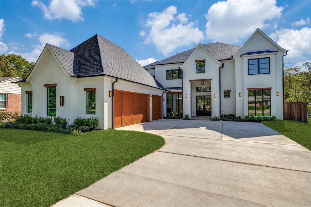 Experience luxury in this stunning new construction home on a 0.32-acre lot in the coveted Midway Hollow neighborhood. The striking facade is enhanced by a three-car garage featuring cedar wood doors.

From the grand porch, you are welcomed into a beautiful foyer. Flanking the foyer, the formal dining room captivates with its soaring ceilings. The open-concept design connects the living, kitchen, and breakfast areas, overlooking a serene backyard through premium Sierra Pacific windows and sliding aluminum doors. The living room boasts striking ceiling beams and beautiful hardwood floors. The gourmet kitchen is centered around a 10-foot waterfall quartz island, a quartz backsplash, and top-tier KitchenAid appliances, including a built-in fridge and a 48-inch gas range. 
The main floor hosts a tranquil primary suite. Its spa-inspired bathroom is appointed with dual sinks, a freestanding tub, dedicated makeup vanity, and a custom walk-in closet. An additional ensuite bedroom, private home office, and a stylish powder bath complete the first level. Ascend to the second floor to a spacious game room, media room, three generously sized bedrooms, and three full baths.

The commitment to quality is evident in foundational elements, including foam insulation in the master suite and porch, three Carrier HVAC systems, two Navien tankless water heaters, a foundation drip system, a smart Rachio irrigation system, and stone retaining wall. Hardwood floors flow throughout the home, except for the media room, to enhance acoustics. The downstairs baths, bar, and fireplace areas are elevated by designer tiles from Porcelanosa, Tile Shop, and Mirrella. Custom white oak cabinetry is featured in the kitchen, master bath, bar, secondary downstairs bath, and mudroom.
The outdoor area offers a covered patio with a kitchen and sink. This home exemplifies exceptional craftsmanship, providing a luxurious lifestyle in one of Dallas’ most desirable neighborhoods. Agent also home builder.