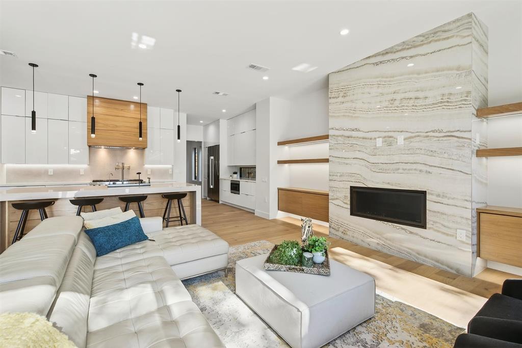 A masterpiece for those seeking a turnkey lifestyle in the heart of Dallas' vibrant Bird Streets. The seamless flow of the expansive living area invites you in, where sleek wood floors, modern lighting, and carefully curated décor create an atmosphere of refined sophistication. At the heart of the home is the contemporary kitchen, equipped with top-of-the-line Jenn Air appliances and complemented by a butler’s pantry-prep kitchen, ensuring every detail is in place for effortless entertaining. Beyond, the formal dining room offers a stunning setting for gatherings, blending elegance with warmth.
The primary suite is a personal sanctuary designed to indulge and inspire. Its spacious walk-in closet connects directly to the laundry room, a thoughtful touch simplifying daily routines. Outside, the magic continues in the private backyard oasis, featuring a sparkling pool and jacuzzi, surrounded by spaces perfect for everything from lively celebrations to peaceful evenings. Every corner of this home has been crafted for a balance of connection and escape, making it an unparalleled retreat.
Upstairs, the story unfolds with a flexible design tailored to adapt to your needs. A spacious loft with a wet bar becomes the ultimate spot for relaxation or hosting, while a comfortable junior suite ensures privacy. Two additional bedrooms offer space for family or guests, while the bonus theater room, ready for movie nights or repurposed as a gym or office, adds versatility. A second laundry room and thoughtful details throughout underscore the home’s blend of practicality and luxury.
Just minutes from Love Field and within walking distance of bars, restaurants, and shops, this is more than a home—it’s a lifestyle. Every detail has been meticulously considered, from the flow of the spaces to the exquisite finishes, offering a truly turnkey retreat in one of Dallas’ most sought-after neighborhoods.  This is where your next chapter begins.