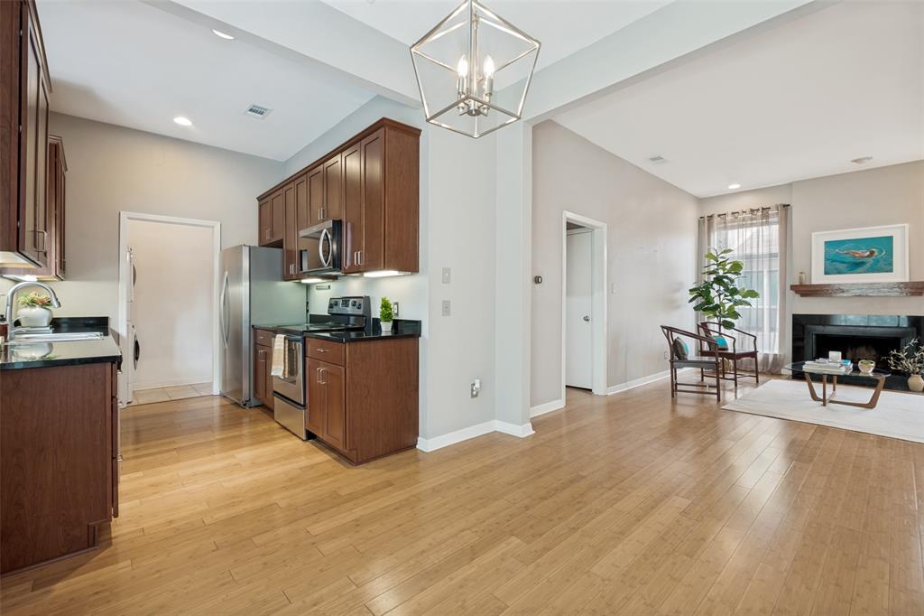 Spacious top-floor one-bedroom condo situated in the heart of vibrant North Oak Lawn. Light filled interiors boast soaring ceilings, oversized windows, hardwood floors and a center wood burning fireplace that anchors the living space. The well-appointed kitchen includes custom cabinetry, granite countertops & stainless appliances, while the generous bath features a dual-sink vanity and skylight. The primary suite offers recently installed hardwoods and sizable closet with Elfa shelving system. Conveniently located in the center of Dallas just steps from Turtle Creek, Highland Park and the city’s best retail and dining. 4031 Holland is a small condo community comprised of just 8 units and is secured by a gated perimeter fence. Unit G includes 1 assigned covered parking space.