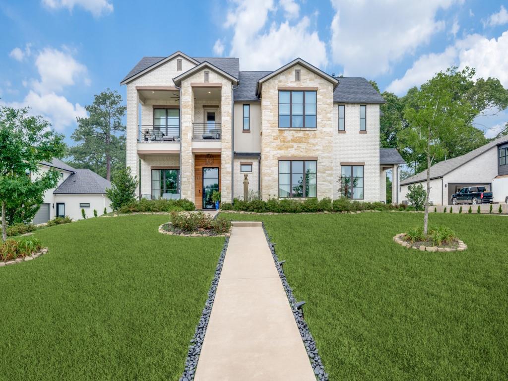 Custom home with a combination of luxury and resort style living. 4 bedrooms, Formal Dining, Study, Gameroom, 3 car garage and outdoor kitchen and living area. Master suite has sitting area, luxury bath with separate seamless glass shower and tub, walk in closet. Mother in law suite has sitting area, walk in closet, private bath, kitchenette area and private entrance with porch. Open floorplan greats you with private study with french doors, spacious formal dining is open to living and kitchen area. Living area has built in shelves and tiled floor to ceiling fireplace. Upstairs has 2 additional bedrooms with private baths. Large Gameroom is great for entertaining and open to outdoor balcony that overlooks the lake. The custom outdoor kitchen is a must see!  This kitchen is a chefs delight with many built ins, ceramic till backsplash, including pizza oven, refrigerator, ice machine, grill, flat top grill, power burner, sink, storage drawers. House overlooks the lake! Additional landscaped yard on top of hill with custom firepit. This house is a must see!! Roof only 2 years old.