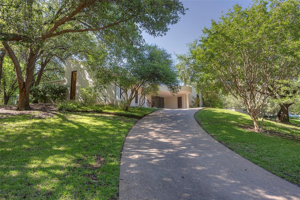 Stunning Westover Hills contemporary on 0.76 acre tree filled, elevated lot. Featuring 4 bedrooms with 4.5 baths, additional building in back of the lot that could be a guesthouse, pool house or extra garage. Value is in the land! Could be remodeled or your new dream home built in this amazing location. Office with art storage, bath off backyard ideal for pool.