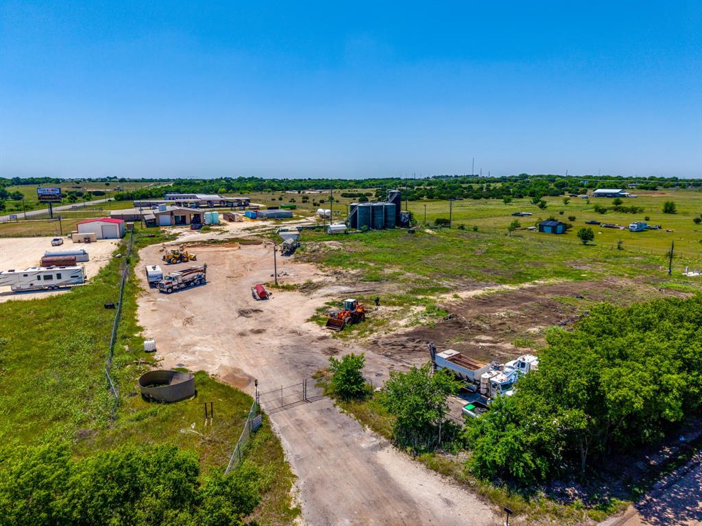 This industrial property is located outside city limits 10 minutes away from the new Amazon warehouse.  The property consists of 4.6 acres, has three phase electricity, and an industrial well.  The property has several large water tanks.  The property is gated which makes it great for outside storage businesses or to house large truck fleets and machinery.