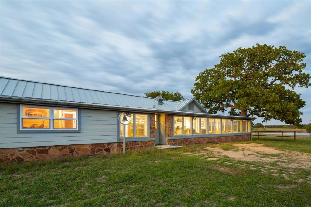 This home was the original Ranch house, This house was built with rocks found on the property.   There are some artifacts embedded in the walls of the house, such as Indian arrow heads. May be more!  Come and see for yourself!  
The kitchen has granite and the wrap around sunroom brings light and warmth all day with views of a nearby pond.  Perfect place for your morning coffee to see all the wildlife who are regulars at the pond.  And the sunrises are spectacular! 
This home was previously used as an Airbnb and had some regular visitors who rented the home for family gatherings.  It offers a romantic getaway but still close to city conveniences and nightlife.  Furnishings available to purchase.  Also available to purchase is an addition 5 acres, 3650 Pleasant Valley Rd.
Key Features:
• Gated Community: River Bend Ranch is a gated community, providing a sense of security and exclusivity.  
• AG Exemption: Low property taxes are available through the AG Exemption status via the Cattle Grazing Association. Dues $912 year
• Community Lot: A 5-acre community lot offers access to the Brazos River. 
• Location: The community is situated in Mineral Wells, Texas, providing a blend of rural living and access to local amenities. 
• Recreational Opportunities: The area offers various recreational activities like hiking, spas, mineral baths, and wellness centers, thanks to the city's history as a health resort.