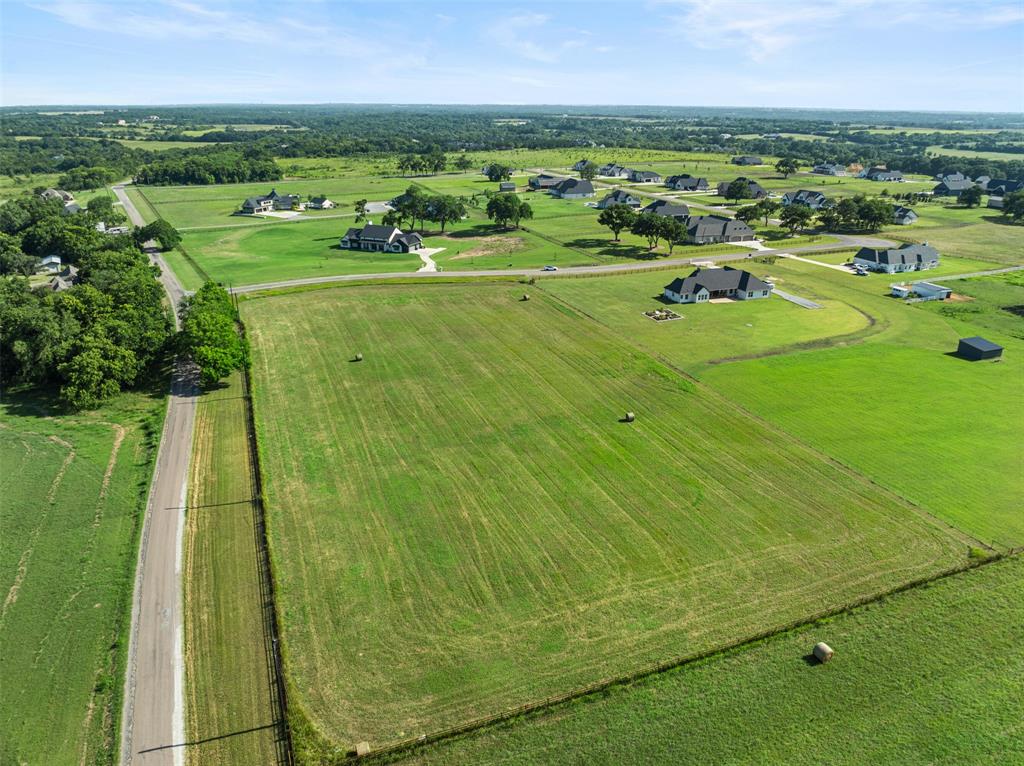 The LAST remaining estate lot in the picturesque neighborhood of Pearlace! Build your completely custom home on this approximate 5-acre corner lot. Fenced on 3 sides with steel post and rail fence already installed on northern & eastern borders of the property & additional fence on the western border. Barn, guest house or casita allowed. Horses allowed. Enjoy peaceful country living at its finest with easy access to Hwy 75, 121 & 455. Deed Restrictions & HOA with low annual HOA dues. Outside of the city limits so NO city tax! Award winning Van Alstyne schools. Buyer will have up to 2 years to start construction. Secure your lot while designing your dream home!