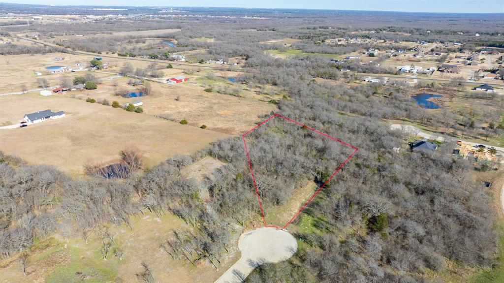 Nestled on 2.13 acres of peaceful, wooded land in the highly desirable Vista Oaks Estates east of Dallas in Royse City, Texas, this remarkable parcel offers an exceptional opportunity to build your custom dream home. Surrounded by towering oaks and mature hardwoods, the setting feels private, serene, and timeless. Imagine a thoughtfully designed custom residence that takes full advantage of the natural contours and views with wide porches overlooking secluded green space.This quiet and tranquil location is just minutes from major thoroughfares and conveniences, yet it feels worlds away from the ordinary. Whether it’s a sprawling ranch-style haven, a modern farmhouse with open living spaces, or an elegant estate with outdoor entertaining areas and a pool, this lot provides the perfect canvas for refined country living with easy access to the city.