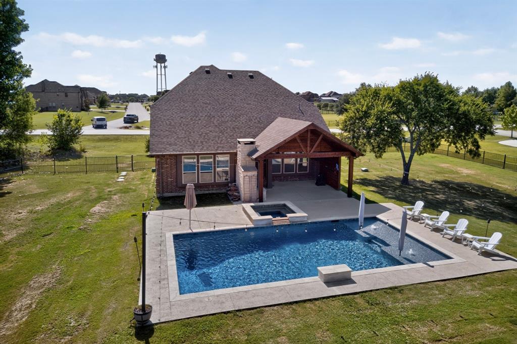 This is the kind of property that doesn't come around often sitting on over an acre of space, country charm, and a backyard built for serious entertaining, all just minutes from downtown McKinney. The split-bedroom floor plan delivers the privacy buyers crave, with a dedicated home office at the front of the home for remote work. A formal dining room sets the stage for hosting, while scraped hardwood floors add warmth and character throughout the main living areas. The kitchen opens directly into the living room, where high ceilings, a fireplace, an island, and a breakfast bar create a space that's both grand and inviting.
The primary suite offers a private retreat with dual sinks, a soaking tub, and a separate shower. Upstairs, a loft adds flexible living space, while brand-new carpet (July 2026) gives the upper level a fresh feel.
Outside is where this home truly shines. The tree-lined backyard offers a private setting with an inground pool, hot tub, covered patio, and striking stone fireplace. A pool fence conveys with the home, along with solar screens for the upper windows and additional lower-level screens. Tucked into the back corner of the yard, an 18x25 spray foam-insulated workshop or storage building provides exceptional space for projects, hobbies, or storage. A new wrought iron fence installed in 2025 expanded the usable backyard.
Major updates include both hot water heaters and the upstairs HVAC replaced in March 2026, annual HVAC maintenance, and a newer dishwasher (3 years old).
Zoned to Melissa ISD, consistently ranked among the top school districts in Texas. US-380 and Hwy-75 keep commuting simple, with Dallas approximately 35 miles south. An acre of land. A backyard built for living. A location that delivers. This one is worth experiencing in person!