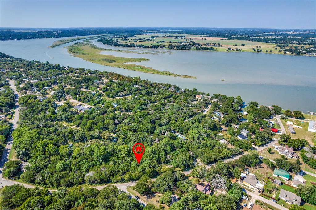 Affordable lots near Lake Granbury are becoming harder to find, making this an opportunity smart buyers will want to notice. Just moments from the water, this 2,796 sq. ft. homesite offers the freedom to build now, hold for the future, or secure a valuable piece of land in one of North Texas’s most desirable lake communities.

Picture a charming cottage, a lock-and-leave weekend retreat, a low-maintenance retirement home, or an income-producing investment property in a location people love to visit year-round. Surrounded by mature trees and the natural beauty of the area, this lot offers the kind of setting that turns plans into reality.

Enjoy quick access to boating, fishing, paddleboarding, lakeside relaxation, and all the outdoor recreation that makes Granbury such a destination. Just minutes away, Granbury Square offers boutique shopping, local dining, live entertainment, and seasonal festivals that give the area its unmistakable charm.

Parks, walking trails, golf courses, grocery stores, healthcare, and everyday conveniences are all nearby, with easy access to Highway 377 for a smooth drive to Fort Worth and the greater DFW area.

Whether you’re looking for lifestyle, future value, or a simpler path to ownership, this lot checks the boxes. Opportunities like this do not stay overlooked forever. Secure your place near the lake and start building what’s next.  No survey