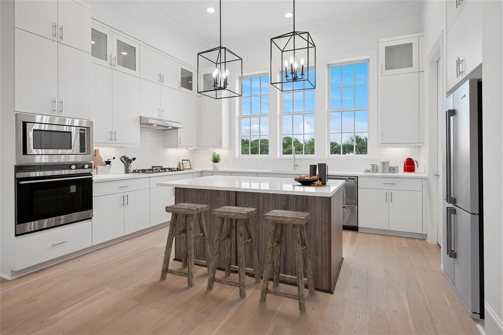 GORGEOUS NEW 4 STORY TOWNHOME WITH SPACIOUS ROOF DECK! JULY 2026 COMPLETION. Discover this one-of-a-kind 4-story townhome designed for modern living with a unique open floorplan, soaring 12-foot ceilings, and expansive Anderson windows filling the home with natural light. Featuring 4 bedrooms, 4.5 baths, and a 2-car garage with electric car plug. This home combines elegance with everyday convenience. Step inside to all wood floors and custom wood trim detailing throughout. The gourmet kitchen is a chef’s dream with modern double stacked, furniture grade soft-close cabinetry, upgraded Fischer and Paykel appliances, stunning quartz countertops, and a large island perfect for entertaining. Kitchen opens to a  spacious dining and living  room with Marble Fireplace for added ambience! Retreat to the spacious primary suite with a spa-inspired bath boasting of marble floors, walk-in shower, large soaking tub, and oversized walk-in closet. The 4th level is an entertainer’s dream featuring a large game room which opens with 10ft sliding glass doors to a private roof deck.  MUST SEE !Located in the heart of Addison, this home offers unmatched convenience—steps from the Addison Athletic Club, just 1 mile to the North Dallas Tollway, minutes from Addison’s Restaurant Row, DFW Airport, Love Field, Galleria Dallas, and Legacy West. Don’t miss this rare opportunity to own a move-in ready townhome in one of DFW’s most desirable urban communities! LOW $145 per month HOA.