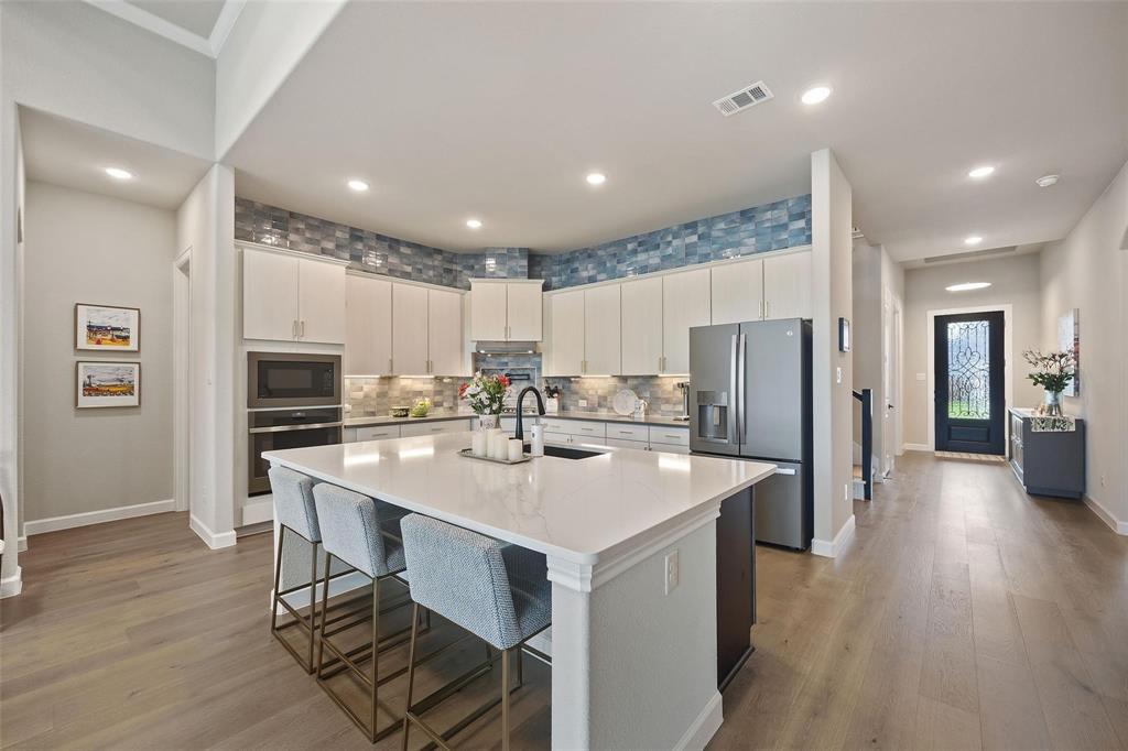 MOVE-IN READY in Rockwall’s Sonoma Verde and now priced under $600K. This 2021-built home offers the floor plan buyers keep asking for: 3 bedrooms down, a private office, 3-car garage, and a huge upstairs game or media room. The home is already upgraded with solar panels, a whole-home water filtration system, and an expanded patio with dedicated grilling and seating areas, giving the next owner more value without the wait or extra expense of adding it later. Inside, the open kitchen features an oversized island, gas cooktop, walk-in pantry, and easy flow into the dining and living areas, making everyday living and entertaining simple. The first-floor primary suite offers natural light, dual vanities, a soaking tub, separate shower, and spacious walk-in closet. Upstairs, the large flex space is perfect for movie nights, gaming, hobbies, guests, or a second living area. Unlike new construction, the upgrades are already done, the home is vacant, and the next owner can move in without waiting on a builder timeline.