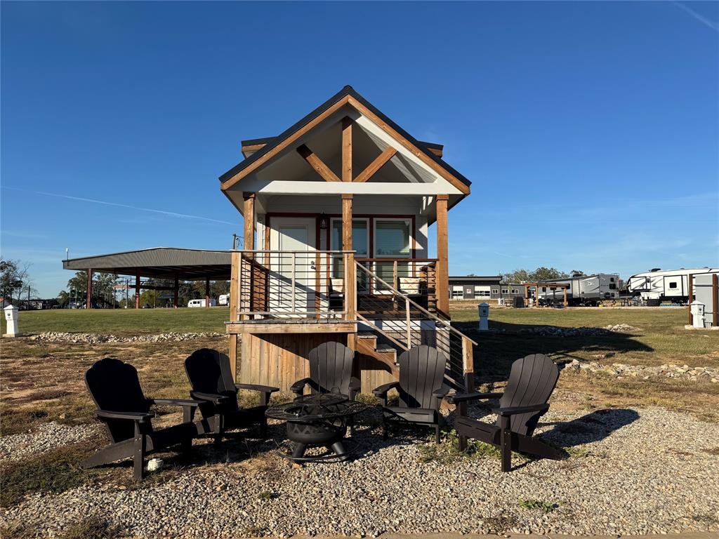 Escape to tranquility with this stunning, fully furnished tiny home—an extraordinary, potentially once-in-a-lifetime chance to own both an exclusive lakefront lot and a beautifully designed residence nestled within the breathtaking Twin Lakes Resort in Mount Pleasant, Texas. Perfect for unforgettable weekend getaways or a brilliant investment, this one-of-a-kind retreat blends luxury and nature, offering an unparalleled opportunity for an Airbnb host to generate substantial income with minimal effort. Step inside this rare gem, featuring an open-concept layout, a gourmet kitchen with sleek, modern appliances, and a seamless design that maximizes space and comfort. The home includes one king bed and one queen bed, plus generous additional space for sleeping bags or cots, easily accommodating larger groups. A full bathroom inside the home, paired with separate on-site showers available at the resort, ensures a convenient and relaxing stay for you or your guests. Enhanced by numerous upgrades, this property exudes modern luxury. Outside, an expansive outdoor living space beckons, complete with your very own fireplace—perfect for unforgettable nights under the stars or savoring morning coffee with mesmerizing lake views. Owning this exclusive lakefront lot grants you the rare privilege of enjoying Twin Lakes Resort’s stunning scenery and exceptional amenities: fishing, hiking, pickleball, indoor and outdoor pools, basketball courts, shuffleboard, a splash pad, a playground, and serene lakefront vistas. Whether you seek relaxation or adventure, this tiny home is the ultimate sanctuary. Best of all, if you choose to make this an income property, you can relax and watch your investment flourish while a dedicated property management team takes care of booking, cleaning, and maintenance for a small percentage of the profit. This isn’t just a peaceful haven for guests—it’s a hands-off, lucrative income stream and a singular chance to own a slice of paradise inMount Pleasant!