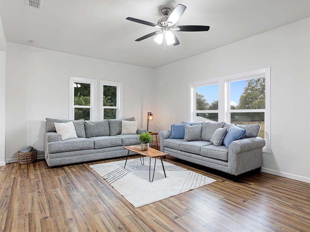 Welcome to this stunning fully remodeled 4-bedroom, 2-bathroom home nestled on a generous .34-acre corner lot with a huge backyard in the charming town of Bowie, Texas! Every inch of this home has been thoughtfully updated to offer both modern style and everyday comfort. Step inside to discover fresh interior and exterior paint, new flooring throughout, and decorative lighting that sets the perfect mood in every room. The roof was new in 2023. Enjoy the spacious layout with two separate living areas, ideal for entertaining, relaxing, or creating a flex space for a home office or playroom. The kitchen is a true showstopper, featuring sleek countertops, lots of cabinets, modern fixtures, and nice appliances. Both bathrooms have been fully renovated with elegant tile work, stylish vanities, and updated fixtures. Why Bowie? Located just an hour from the DFW Metroplex, Bowie offers the perfect blend of small-town charm and convenient access to big-city amenities. Known for the World’s Largest Bowie Knife and the vibrant Second Monday Trade Days, one of the oldest and largest open-air markets in Texas, this town is full of rich history, community events, and down-home Texas hospitality. Don’t miss your chance to own a slice of Bowie, where charm meets modern living. Schedule your private tour today!