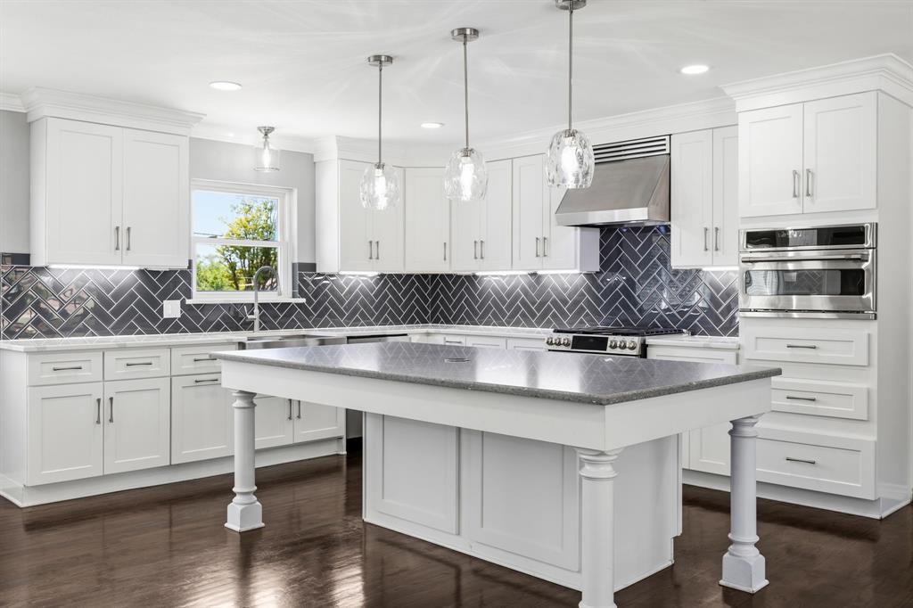 Stunningly renovated two story home situated on an impressive 100 foot wide, third acre lot in one of Oak Cliffs most sought after neighborhoods, Wynnewood Hills. This well established, tree lined community sits adjacent to The Golf Club of Dallas and is known for its custom homes on expansive lots. From the moment you arrive, the circular drive and stately curb appeal set the tone. Inside, richly stained hardwood floors flow throughout the home, creating warmth and timeless style. The beautifully updated kitchen is the centerpiece of the home’s functional layout, featuring quartz countertops, stainless steel appliances, a natural gas range with designer vent hood, apron-front farm sink, wine fridge, and a large island ideal for casual dining and entertaining. Enjoy the flexibility of two potential primary suites, one upstairs and one downstairs, both offering ensuite baths and walk in closets. The formal living area at the front of the home provides versatile space that can easily serve as a home office, dining room, or additional living area to fit your needs. A warm and inviting family room designed for comfort and relaxation features rich wood flooring and a cozy wood burning fireplace. Large windows fill the room with abundant natural light, enhancing the open, airy feel and creating a bright yet tranquil atmosphere, ideal for unwinding or spending quality time with family and friends. The spacious backyard is perfect for entertaining, offering three distinct outdoor areas and plenty of yard area, providing ample space for your family and friends gathering events. A rear entry two car garage provides added convenience and vehicle protection from Texas weather. Ideally located with quick access to Highway 67 and I35, you’re just minutes from downtown Dallas, Bishop Arts District, and Oak Cliffs new 5 acre Halperin Park. Don’t miss this exceptional opportunity to own a beautifully updated home in the heart of Oak Cliff!