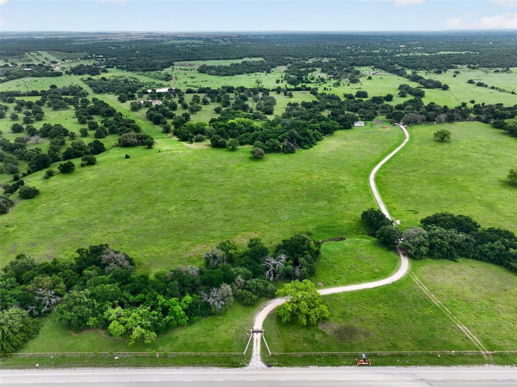 14145 S US-281 and the adjacent 2773 Palo Pinto County land parcel offer approximately ±137.76 acres in Santo, Texas, consisting of an approximately ±134.29-acre land tract and an approximately ±3.47-acre residential estate parcel. The 2773 tract has frontage along both US-281 and the I-20 access frontage road, providing dual-corridor exposure near the US-281 and I-20 interchange. The property includes open acreage, mature tree coverage, pastureland, agricultural support structures, and an existing residential improvement.

The 14145 S US-281 parcel includes an approximately ±4,909 SF two-story ranch-style residence with five bedrooms, five bathrooms, multiple living areas, a large great room, second-floor balcony, attached garage, covered porches, and workshop support. The fifth bedroom is located above the garage and may function as a flex room, studio, workspace, guest area, or caretaker manager space, with access from both the garage and rear exterior through a shared staircase. Property features and potential uses should be independently verified by buyer, including zoning, permitting, utilities, access, frontage, and suitability for any intended use.