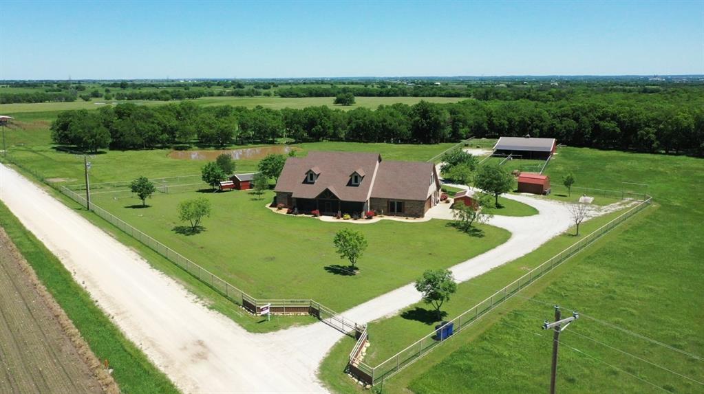 Welcome to your dream retreat! Set on nearly 14 acres of serene ranchland (with an additional 32.22 acres available for purchase), this exquisite custom-built home masterfully combines luxury and country living. Featuring 4 spacious bedrooms and 3 bathrooms, this residence offers the perfect balance of comfort and style. Highlights include a stunning rock fireplace and elegant granite countertops in both the kitchen and bathrooms. Beautifully designed patios provide a perfect setting for outdoor relaxation and enjoyment. The open concept layout effortlessly connects the living, dining, and kitchen areas, making it ideal for entertaining family and friends! 

Step outside to explore the partially fenced and cross-fenced property, complete with tranquil ponds—perfect for unwinding or observing local wildlife. The property also features top-of-the-line equestrian and agricultural facilities. The impressive 40x60-foot barn is a horse lover's dream, offering horse and calf stalls, a corral, loaf shed, hay loft, and feeders, catering to all your equestrian and farming needs. Additional amenities include  a garden shed, and a storm shelter. A 50' x 110' covered hay barn offers potential for conversion into an arena.
 
With endless possibilities for events, hobbies, or creating the workshop of your dreams, this property offers both function and charm. Conveniently located just an hour from DFW Airport, you can enjoy the peace and tranquility of rural living while remaining close to city amenities. Enjoy nearby wineries, distilleries, and entertainment, including WinStar Casino and Resort (20 mi), Arché Winery & Vineyard (37.7 mi), Blue Ostrich Winery (38.3 mi), and more—all within 40 miles of this prime location. This rare find harmonizes luxury, practicality, and natural beauty!

**Additional 32.22 acres available for purchase..