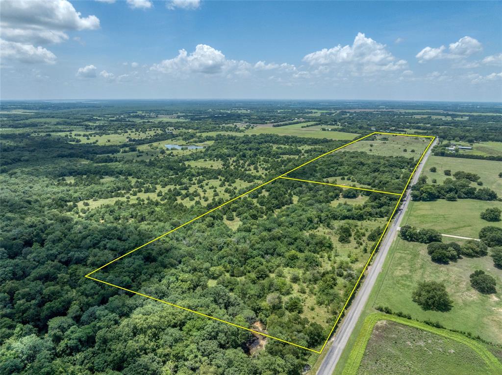 Presenting a remarkable opportunity to own a substantial slice of country paradise in charming Farmersville. This extensive ag exempt property on two parcels invites visionary entrepreneurs and nature enthusiasts to explore over 66 acres of versatile land, perfect for various agricultural, recreational, or investment pursuits. With its expansive layout and its position on a corner lot, this land promises optimal accessibility and exposure, ideal for diverse ventures. Two ponds and Indian Creek brings wildlife into the picture.  Water meter is already installed and working on the property. Owner will consider selling parcels separately. One is 44 acres and one is 22.5 acres.