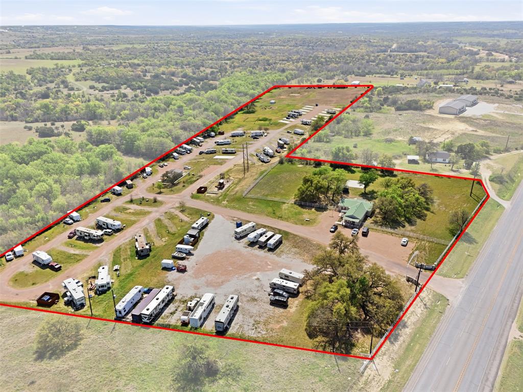 Prime 16-acre income-producing opportunity! This established RV park features 85 spacious sites, each equipped with full electric, water, and sewer hookups, catering to both short-term guests and long-term residents. A scenic creek runs along the back of the property, adding a peaceful, natural setting that guests will love.  Perfectly positioned between Springtown and Weatherford, this property offers the ideal balance of quiet country living with convenient access to everyday amenities, shopping, grocery stores, and restaurants are all within 10–15 minutes. For recreation, enjoy being just minutes from the popular Eagle Mountain Lake, one of the area's favorite destinations for boating and outdoor fun. And when you're ready for city life, Downtown Fort Worth is only a 35 minute drive.  With strong existing infrastructure and 5 acres that has not been developed on yet there is plenty of room for future expansion or added amenities, this property presents incredible income potential and long term growth opportunities. Whether you're an investor or owner-operator, this is a rare chance to own a thriving RV park in a highly desirable location.