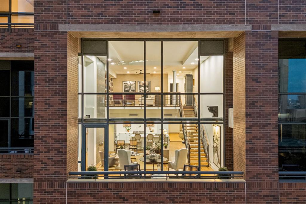 Experience elevated loft living in this extraordinary architecturally reimagined loft residence at 1999 McKinney, where sophisticated design meets effortless luxury. Following an extensive eight-month renovation, this exceptional home was meticulously reimagined with an uncompromising commitment to craftsmanship, refined finishes, and intelligent design.
Created to maximize openness, storage, and functionality, the residence blends modern elegance with timeless style. Custom millwork, suspended drywall ceilings, designer finishes, and Lutron lighting create a warm, gallery-inspired ambiance.
The chef's kitchen was rebuilt from the original sheetrock and features a dramatic quartz waterfall island, custom cabinetry, a sculptural range hood, professional-grade appliances, a pot filler, built-in wine refrigerator, and a custom dry bar—perfect for entertaining.
The dramatic living room showcases soaring ceilings, an expansive wall of glass, captivating city views, and an elegant fireplace framed by a striking two-story tile feature. Programmable accent lighting creates the perfect setting for displaying artwork.
The primary suite, a luxury private retreat, features a spa-inspired bath, a custom walk-in closet, and an additional secondary closet.
Every bathroom, floor, ceiling, lighting fixture, closet, and designer finish was thoughtfully selected to create a cohesive, turnkey residence.
The floor plan offers 2 bedrooms, a dedicated office, 2 living areas, 2 private balconies, and 2 oversized storage units.
Perfectly positioned in the heart of Uptown, residents enjoy exceptional walkability to premier restaurants, cafés, luxury boutiques, grocery stores, Klyde Warren Park, the Arts District, and world-class sports and entertainment venues. Amenities include a resort-style pool, outdoor grilling area, fitness center, and lock-and-leave living.
A rare opportunity to own an impeccably renovated luxury residence in one of Uptown Dallas' most desirable addresses.