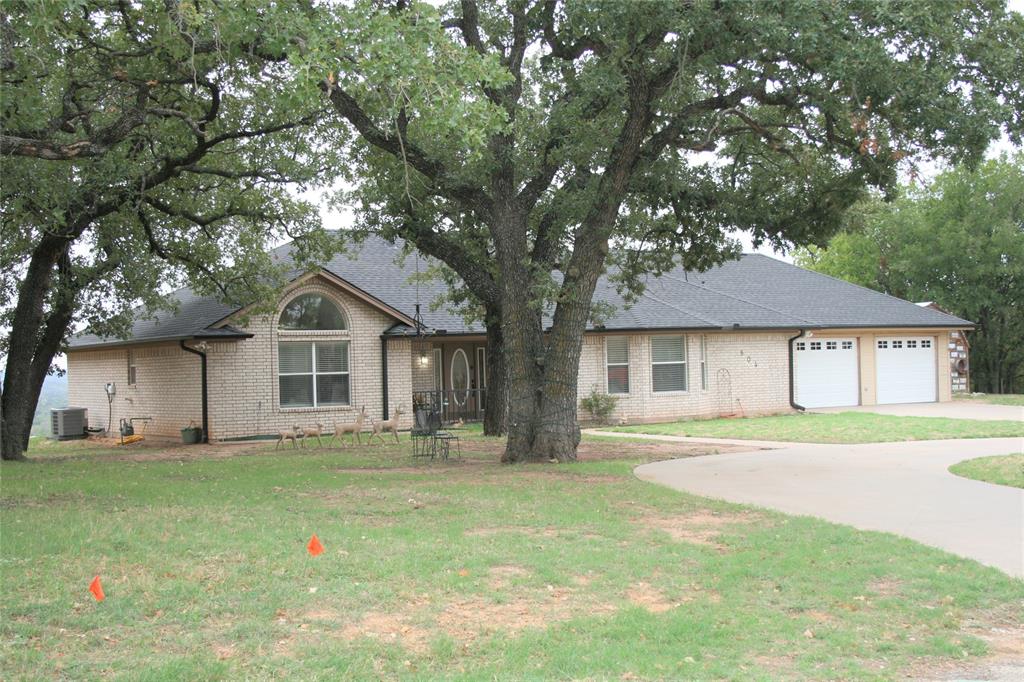 This custom built home has many extra features that you will need to see. The covered back porch gives you plenty of room to entertain and gives you a long distance view toward the south, or gives you a nice view of downtown Mineral Wells. You are in the city limits, but the area gives you a relaxing country atmosphere watching the deer. The bonus room is a 12 by 10 safe room in the basement area. Everyone is looking for the split bedrooms, and open concept living, dinning, and kitchen area. You also have a circle drive, RV parking, and an oversized double car garage. There is a third garage door so you can bring in yard equipment, or have good ventilation when you are doing that summer work project. The back 25 x 15 covered porch is perfect for quests, and the rock patio has a cooking area and a hot tub area. There are many trees, and you have a sprinkler system to keep the landscape looking good. There are also solar panels on the back side of the roof to help with electric costs.