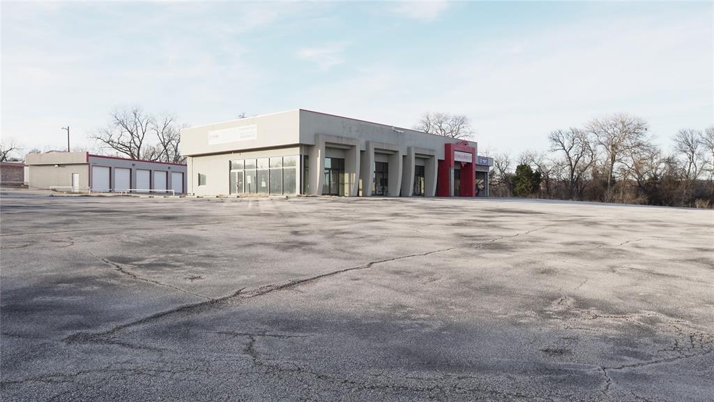 This location is ideal for your Automotive, ATV, Boat, Tractor Dealership, restaurant, or a multitude of other retail uses. Within minutes of the new Texas IT corridor, directly across from Albertsons.   Much sought after corner in the heart of growing Sherman Texas retail and business district.  4500 SQ FT and 3000 SQ FT buildings.  U.S. Hwy 75 frontage showroom and service center.  Retail, medical, dining, offices, dealerships, financial, grocery, and much, much more surround this outstanding location.  Call today to schedule your showing appointment.  Was an operating automotive dealership. 4 showroom offices, upstairs partially finished could be 4 offices of more, 7 bay shop, parts and service counter with storage and office. Pipe gates.  New complete photos to be uploaded by Feb 3rd.