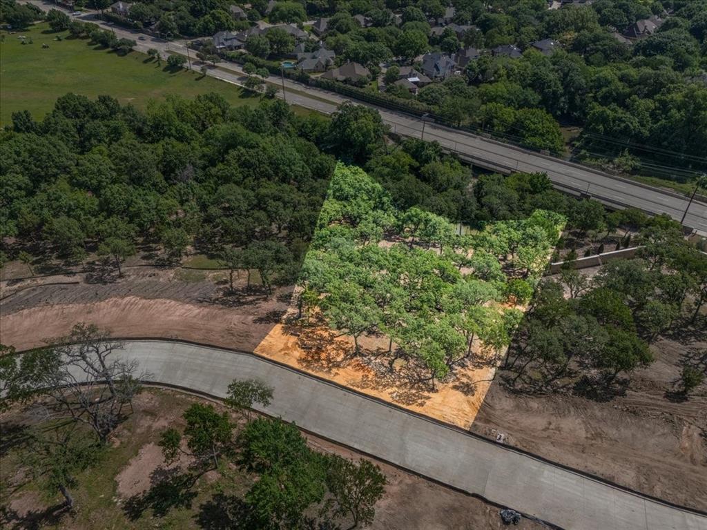 Welcome to The Bluffs, an exclusive gated luxury community of only 9 estate home sites nestled atop the rolling, wooded hills of Colleyville. Lot 2 presents a rare opportunity to build your custom dream estate on a generous 1+ Acre home site, surrounded by mature trees and bordering a natural creek.

The Bluffs is more than a community—it is a lifestyle. With only 9 home sites in this private enclave, residents enjoy breathtaking elevated views, unmatched privacy, and a tranquil atmosphere defined by the natural beauty of the surrounding woodland and creek. Just across the street, Parr Park provides immediate access to trails, open green space, and outdoor recreation for the entire family.

Residents are served by Grapevine-Colleyville ISD, including Glenhope Elementary, Cross Timbers Middle School, and Grapevine High School—consistently recognized among the top-performing districts in North Texas. World-class shopping and dining at Southlake Town Square and Colleyville Town Square are just minutes away. DFW International Airport is approximately 10 minutes from your door, with Downtown Fort Worth roughly 20 minutes and Downtown Dallas approximately 25 minutes away—placing the best of the Metroplex always within reach. Your legacy estate in The Bluffs begins here.