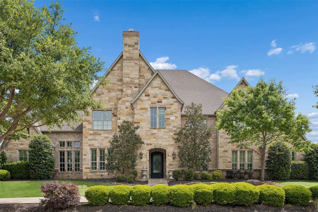 Exquisite craftsmanship & timeless elegance define this extraordinary Hatfield Custom Home, gracefully situated on a sprawling 1 acre estate in the prestigious St. Emilion community of Southlake. From the moment you step through the grand entry, you are welcomed by soaring ceilings, rich hardwood flooring & an atmosphere of refined luxury. Designed for both intimate living & grand-scale entertaining, the home offers an impressive formal dining room & an elegant formal living space adorned with a statement chandelier, a warm fireplace & plantation-shuttered windows that bathe the room in natural light. A distinguished executive study showcases coffered ceilings, custom built-ins & exquisite wood wainscoting. The main living area is nothing short of breathtaking, featuring vaulted, beamed ceilings & a dramatic floor-to-ceiling stone fireplace, seamlessly blending indoor & outdoor living w-sliding doors that open to the resort-style backyard. The gourmet chef’s kitchen is a true showpiece, appointed w-a grand island, built-in fridge, gas cooktop, double ovens, and a fully equipped butler’s pantry, crafted to impress & perform. Primary suite is a luxurious retreat, complete w-a serene sitting area + a spa-inspired bath offering a jetted soaking tub, dual vanities & a custom WIC. The home continues to impress with a 1st floor game room featuring a wet bar, a fully equipped media room w-theater seating & an additional upstairs game room w-its own Juliet balcony + generously sized guest suites. Every detail has been thoughtfully curated, including a spacious utility room with an oversized island & abundant storage, an exercise room, a wine cellar & a well-appointed guest suite on the main level. Step outside to your private resort oasis, where a covered patio with a stone fireplace & outdoor kitchen overlooks a sparkling pool & spa with a dramatic rock waterfall. The expansive grounds also feature a sport court and ample green space, all complemented by a 4 car garage.