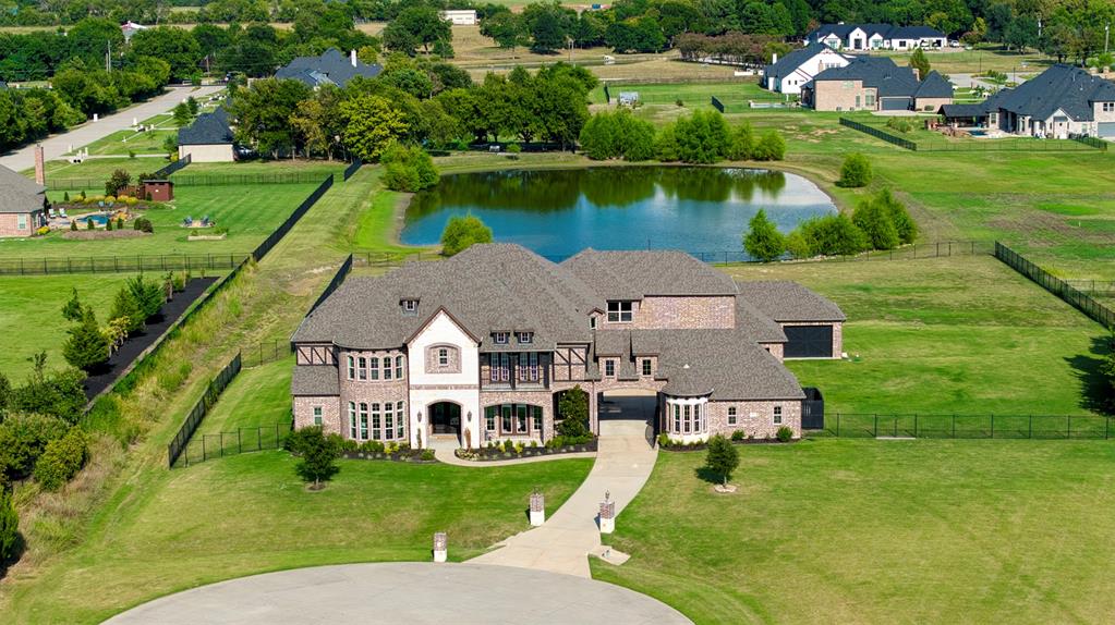 ***Motivated Sellers - Bring your Offer*** Indulge in a rare offering within the exclusive Stinson Highlands enclave of Lucas, where timeless elegance meets modern sophistication across 4.48 acres with tranquil lake views. Privately positioned on a premier cul-de-sac lot, this extraordinary 2018 custom estate spans nearly 8,000 sq. ft. of impeccably designed living. A dramatic entry unveils soaring ceilings, walls of glass, and seamless indoor-outdoor flow curated for grand-scale entertaining. The designer chef’s kitchen is both functional and striking, featuring top-tier appliances, custom millwork, and an oversized gathering island. The primary suite is a true sanctuary, complete with fireplace, spa-inspired bath, soaking tub, dual vanities, and expansive wardrobes. The main level also offers a refined study, private guest quarters, and a dedicated fitness studio. Upstairs, enjoy expansive game and media lounges along with versatile flex spaces. Outdoors, the grounds overlook a serene HOA-maintained lake, offering limitless potential to create a bespoke resort-style retreat. Moments from premier shopping, dining, and top-rated schools in Allen and Plano, this is a statement residence defined by privacy, prestige, and elevated living.