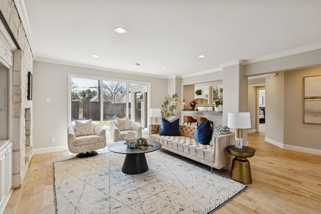 Set on almost a half-acre lot in the prestigious Northwood Hills neighborhood, this stunning home offers the perfect blend of space, comfort, and lifestyle, featuring 6 bedrooms, 4 full bathrooms, and a half bathroom.

Designed for both everyday living and effortless entertaining, the thoughtful floor plan spans two well-appointed levels. Sunlight pours into the inviting living room, where custom built-ins and a warm fireplace create a welcoming focal point. Just beyond, the kitchen blends function and charm with granite countertops, its own fireplace, and seamless connection to the dining room, ideal for hosting gatherings both large and small.

The main level includes a generous primary suite filled with natural light, complete with a spacious ensuite bath featuring a soaking tub and walk-in closet. Downstairs, two additional bedrooms and a full bath provide flexibility for family or guests.

Upstairs, three additional bedrooms offer comfortable accommodations, including two connected by a Jack-and-Jill bath, plus an additional full bathroom. A versatile second living area, dedicated office, and private gym create flexible spaces suited for today’s evolving lifestyle. Step onto the balcony for peaceful views overlooking the backyard.

Outdoors, the backyard is designed for activity and enjoyment, highlighted by a graciously sized sport court and ample space for recreation and gatherings.

Blending generous square footage, functional design, and a prime location in Northwood Hills, this home is zoned to the highly regarded RISD and offers exceptional livability in one of North Dallas’ most established neighborhoods.