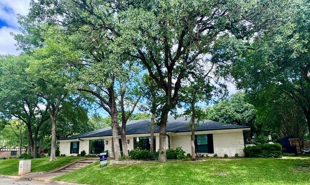 BACK ON MARKET!!! Come and see the crown jewel of Woodhaven Country Club Estates! A palatial ranch style house sitting on hand manicured grounds, the structure is situated facing west by northwest on a corner lot of more than one third acres on iconic and eponymous Woodhaven Ln N. The house is very  conveniently located just a few minutes from Interstate 30, less than thirty minutes from DFW International Airport. This gem has so much to offer! A spacious yet comfortable abode of over forty four hundred square feet which has been meticulously updated with all new double pane windows, new custom made front door, new engineered flooring, new quartz countertops, new custom made built in cabinetry, new lighting and plumbing fixtures, even a newly installed charger for EV vehicles! One of the 5 spacious bedrooms is also an audiophile's dream! It has been customized with highly efficient sound insulation and can be used as a listening room, recording studio, rehearsal space for instrumentalists, or, anything else in which a quiet environment is helpful, like meditation or yoga practice. This stunning home also boasts a large, peaceful mother in law suite featuring a beautifully appointed en suite bathroom. A new water heater which has a six year transferable warranty was just installed to supply the master bathroom and the other full bath located on the south side of the house. The previous owner also had the entire plumbing system replaced and the foundation supported by thirty steel piers installed by the highly rated G.L.Hunt company who have been in business for over 39 years. Their foundation work is backed by a lifetime transferable warranty. The roof is only five years old and the custom landscaping was hand planted and lovingly cared for by the previous owner, who just so happens to be a licensed Master Gardener in the state of Texas. This house is stunning and solid inside and out. Don't miss your opportunity to call this amazing estate your home!