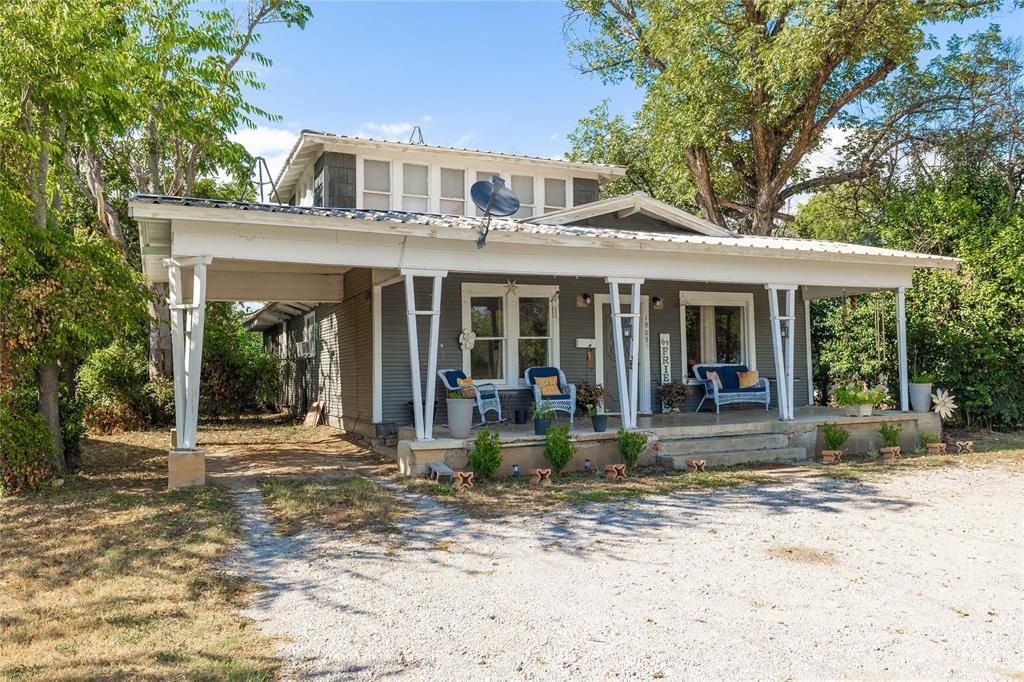Charming two-story, four-bedroom, two-bath home with plenty of character and potential. This older residence features timeless touches, including some original hardwood floors, a durable metal roof, and a welcoming front porch that spans the width of the home—perfect for relaxing afternoons. A smaller side porch offers an additional cozy spot for morning coffee or evening quiet time. Inside, the kitchen is equipped with a gas range for cooking, complemented by an efficient gas water heater and gas heat. The layout provides flexibility, with three bedrooms on the main level and a private primary suite upstairs complete with its own ensuite bathroom, creating a secluded retreat. The large backyard is fenced with chain link, offering space for pets, play, or gardening. While the home could use a little updating, it has solid bones and provides a wonderful opportunity to make it your own. Location is a highlight—situated close to churches, grocery stores, restaurants, and schools, offering both convenience and community. In addition to being a comfortable home, this property is also zoned commercial per city zoning, creating the potential to convert it into a business space with proper approvals. With its combination of character, space, and excellent location, this property offers buyers the chance to create a home or business tailored to their vision.