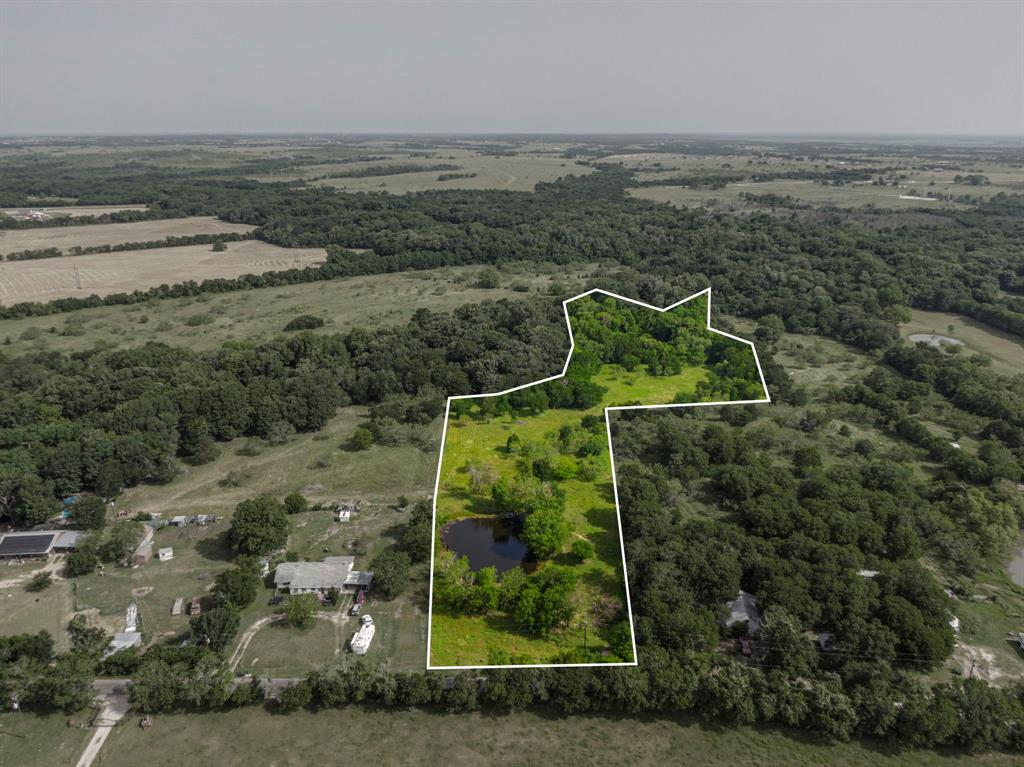 This property is in the country with no city taxes.  There is a pond at the front of the property near the entrance.  Close to the City of Ennis, but you have that feeling of living in the country.  Almost all homes in this area are on acreage.  There is flood zone at the rear of the property which you can see on the survey in Transaction Desk.   There were at one time residents on this lot, so electricity is available through Navarro County Electric Co-op.  Water is supplied by Rice Water Supply. There is a meter on the property near the neighbors water meter.  This property has just been re-platted, so the former address of 1771 Old Telico Road does not apply.  A new address will be assigned after closing. This information comes from the appraisal district.  Front gate is open so you may tour.