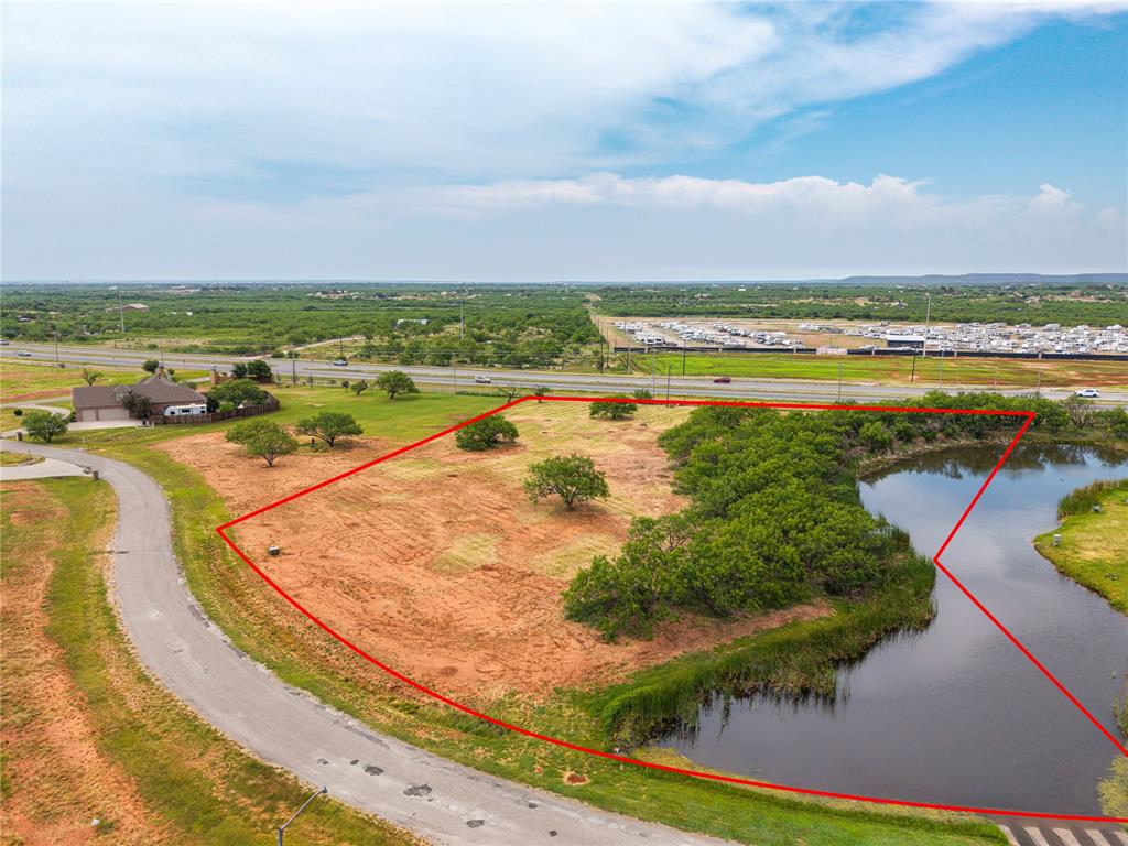 Discover the perfect location for your custom build in Wylie West school district with this stunning 3-acre lot in Abilene's prestigious Mountain Shadows Ranch subdivision. This prime piece of real estate offers incredible convenience, situated just off the highway for easy access. Ready for your dream home, the property's centerpiece is a large, semi-private pond, providing a tranquil and picturesque setting for the luxury lifestyle you've always wanted.