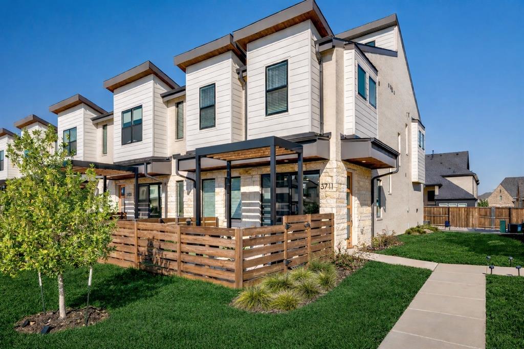Beautiful end-unit townhome located in the heart of Windsong Ranch that seamlessly blends modern design, thoughtful upgrades, and a truly maintenance-free lifestyle with lawn care, landscaping, and exterior maintenance included. As you enter, you are greeted with the latest trends in modern design and architecture, neutral color palette & light oak LVP flooring throughout the first floor. The open-concept main living area features an electric fireplace, designer fixtures and hardware, ample natural lighting from the added windows and end unit location & sliding glass door leading to the extended private patio with pergola that creates the perfect setting for outdoor dining or entertainment. The elegant kitchen showcases premium quartz countertops, high-end induction range, sleek Samsung Bespoke refrigerator, corner pantry and large center island with extra seating! Upstairs, the meticulously maintained patter carpet leads to a versatile open loft area that provides the ideal space for a home office or study nook and a second-floor laundry room with upgraded LG large-capacity washer and dryer included! The spacious primary suite serves as a serene retreat with a vaulted ceiling, generous walk-in closet, and a spa-inspired bath featuring dual sinks, quartz countertops and a frameless frosted-glass shower with bench.The secondary bedrooms and well equipped bath offers a privacy-enhanced split layout with dual sinks, quartz countertops and large closets. Living in Windsong Ranch means enjoying world-class amenities including the iconic crystal lagoon, lakes, multiple pools, fitness center, café, clubhouse, dog park, playgrounds, sports courts, miles of scenic biking and walking trails, and the newly opened Bridge amenity center. The home is within walking distance of top-rated Prosper ISD schools and offers easy access to shopping, dining, and major highways and more!