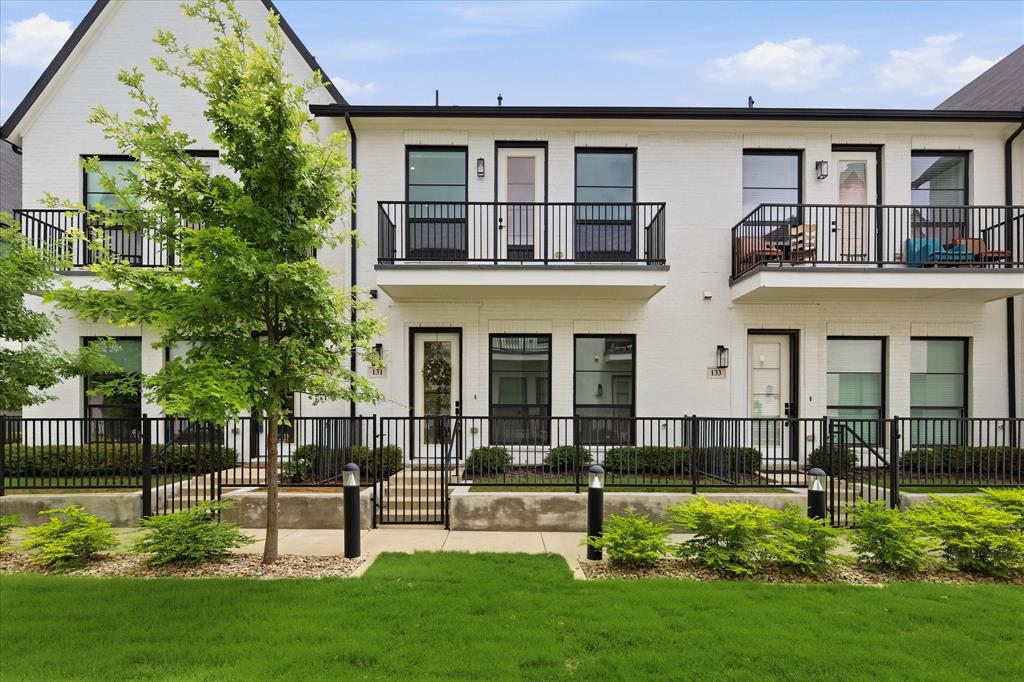 Experience low-maintenance luxury living in the heart of Arlington’s vibrant Entertainment District. Located within walking distance of UT Arlington and just minutes from Texas Live!, Globe Life Field, AT&T Stadium, boutique shopping, and local dining, this GATED Main 7 Urban Villas townhome offers exceptional convenience with easy access to both Fort Worth and Dallas.

Perfectly positioned on an interior lot that does not face or back to a busy street, this two-story home features 3 bedrooms, 2.5 baths, an attached two-car garage, a balcony, and a small fenced front yard with grassy space maintained by the HOA—ideal for a small pet without the upkeep.

The open-concept living area flows seamlessly into the kitchen, complete with a large island, gas cooktop, oven, refrigerator, microwave, and separate pantry. The upstairs primary suite provides a peaceful retreat, while two secondary bedrooms and a shared full bath are located on the first floor. One of the downstairs bedrooms features wood flooring, making it an ideal home office, workout room, or flex space.

Additional highlights: white oak engineered hardwood floors, plush carpet, quartz countertops, custom roller shades, and a full-size washer and dryer that convey with the property. Whether you're cheering on the Cowboys, catching a Rangers game, enjoying nearby restaurants, or simply relaxing at home, this townhome offers the perfect blend of style, comfort, and lock-and-leave convenience. Buyer and buyer's agent to verify school information, measurements and information.