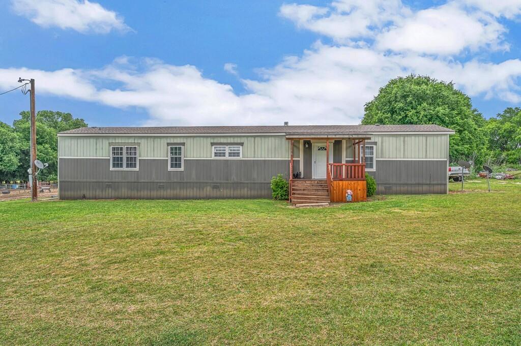 Enjoy country living sitting on approx 17 acres on this well equipped ranch property featuring a 2014 single wide manufactured home.  The roof was replaced March 2025, new AC was replaced June 2023 and the water heater was replaced approx 3 years ago.  This beautiful large open land with water has everything needed for livestock, horses, and equipment storage. The property is fully fenced and offers beautiful open pastureland with scenic meadows, making it ideal for agricultural use or a private homestead.

Horse enthusiasts will appreciate the horse arena with four LED arena lights, multiple stalls including four standard stalls and one oversized stall, plus an 8 X 40 shipping container converted into a functional feed barn complete with built-in saddle racks and horse bridle hooks.

The property also includes a spacious shop with electricity, 220 service, and 110 outlets, along with an additional outbuilding equipped with 220 electrical service and 110 plugs for added flexibility. RV owners will appreciate the covered RV parking with a 30 amp hookup.

Additional features include:
Large stock tank located toward the back of the property
Main security yard light in front of the home
Ag exemption currently in place
Livestock ready setup currently supporting cows, horses, and goats
This versatile property combines functionality, open space, and rural charm — perfect for ranching, recreation, or peaceful country living.