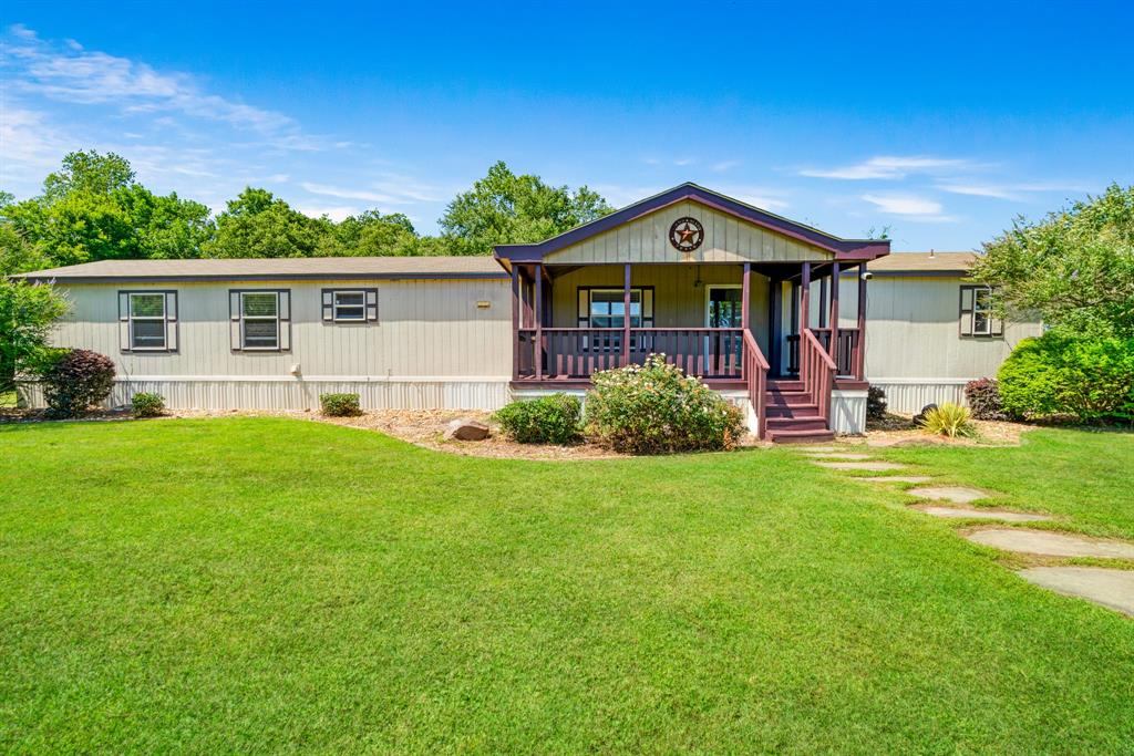 Country seclusion!  This almost 3 acres is a perfect spot for gardening, small business, air BNB, large gatherings or just relaxing!  Property includes 2013 mobile home with 3 bedrooms and 2 baths, gorgeous landscaped custom porch area to sit and enjoy coffee in the morning or cool drinks in the afternoon!  The stars of the show are the two amazing shops, one with a full apartment for guests and the other shop has a newer car  lift that will convey with the property! These shops will meet any of your rv, boat or car storage needs!  You are also just a bikes ride away from beautiful Pat Mayse Lake and all the amenities this beautiful lake has to offer! Property also includes an old country barn which would make a great gathering place or place to do wedding photos etc.! The dog run is a bonus in case you have pets! This is a beautifully maintained place!
