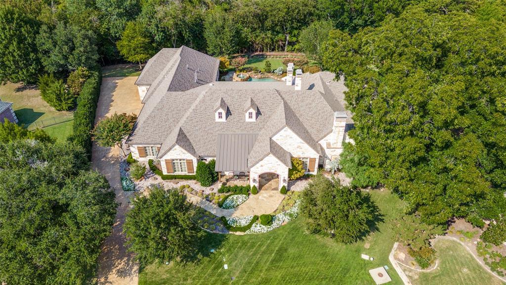 ** Note private remarks. Discover what luxury living looks like.Peace of mind in this gated community w-this private Estate of distinction beautifully situated on a wooded creek lot.Single story Custom home built by Mark Smith w-over 7,000 sq ft of generously sized rooms & 1200 sq ft of enclosed Patio w-breathtaking views of the resort style pool,spa & tree lined backyard.2 Primary bedrooms make this perfect mother-in-law home.Beautiful dbl doors welcome you w-rich hardwood flooring,attention to details & cathedral ceilings.Media rm w-vaulted wood beam ceiling,cozy fireplace,hidden room & BI desk can be a flex room.The family rm opens to the kitchen making this the perfect spot to entertain nestled around a center bar.A panoramic view of outdoor loggia w-FP can be seen from family,breakfast,bar & kitchen.Casual elegance meets Luxury in the Owner's suite w-FP,his & her bath-closets w-private sitting rm.Whether you’re seeking privacy,entertaining or prestige,this home offers it all.