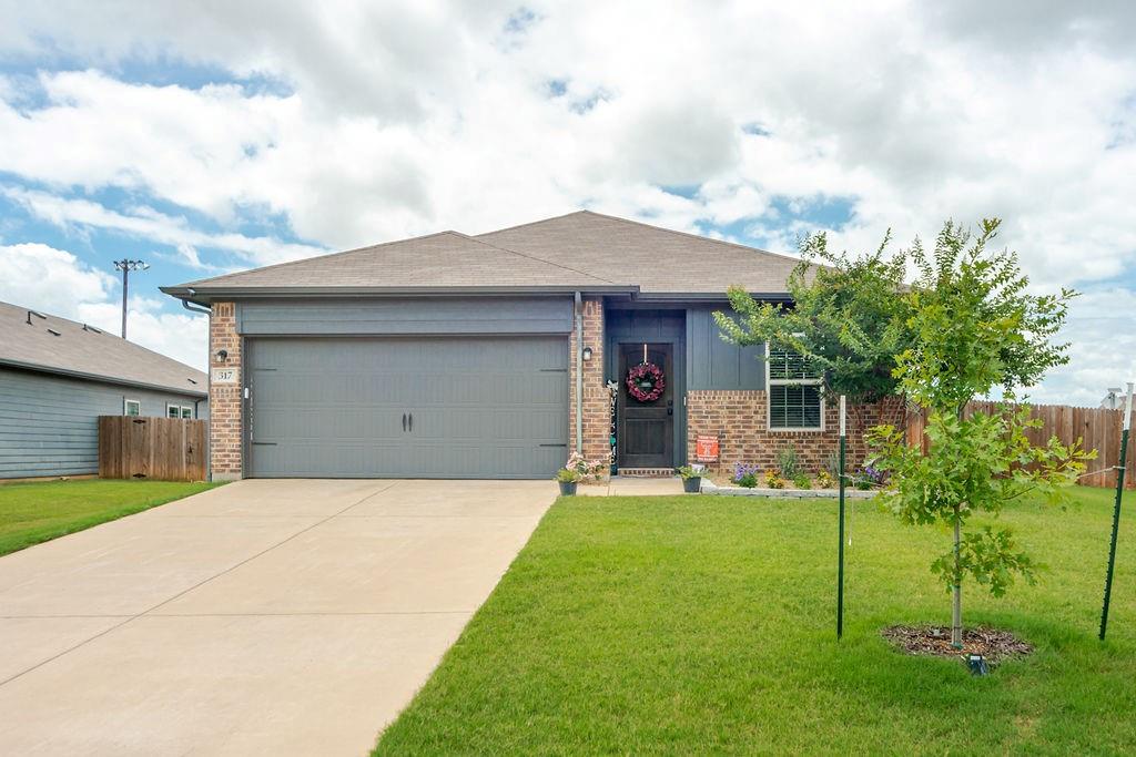 Welcome home to this charming 3-bedroom, 2-bath residence situated on an oversized corner lot of nearly one-third of an acre. Offering a spacious and versatile one-story floor plan, this home features a formal dining area, inviting family room, and a flexible bonus room that can serve as a home office, second living area, or guest room. The well-appointed kitchen is designed for both everyday living and entertaining, showcasing quartz countertops, subway tile backsplash, tile flooring, a walk-in pantry, and a large breakfast bar overlooking the family room. The spacious family room features luxury laminate flooring, a ceiling fan, and is wired for surround sound. The private split primary suite offers a relaxing retreat with a walk-in closet, ceiling fan, updated lighting and fixtures, dual sinks, tile flooring, a garden tub, and a separate seamless glass shower. Two generously sized secondary bedrooms provide ample closet space for family or guests.
Step outside to enjoy the huge backyard complete with a covered patio, full sprinkler system, and gutters—perfect for entertaining or relaxing outdoors. Additional features include a front-entry two-car garage and move-in ready condition.
Located in a desirable community with low HOA dues, no PID or MUD taxes, and low overall tax rates. Conveniently close to schools and a neighborhood park featuring pickleball courts, basketball courts, walking trails, and a playground.Priced to sell and ready for its new owners!