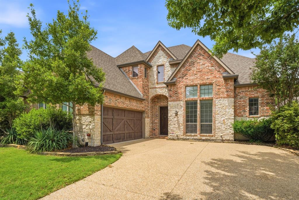 Located in the highly desirable Village Park community and zoned to award-winning Allen ISD, this exceptional home combines timeless style, spacious living, and everyday comfort. Step inside to soaring ceilings, abundant natural light, rich hardwood floors, and a thoughtfully designed open-concept layout ideal for both entertaining and daily living. The expansive living area is anchored by a striking floor-to-ceiling stone fireplace, creating a warm and welcoming focal point that perfectly complements the home’s elegant yet comfortable feel. At the center of the home is a chef-inspired kitchen featuring granite countertops, an oversized island, stainless steel appliances, butler’s pantry, walk-in pantry, and extensive cabinetry. The kitchen flows seamlessly into the living and dining areas, making it ideal for hosting gatherings or enjoying quiet evenings at home.
One of the home’s standout features is the versatile floor plan offering two spacious primary suites — one on the main level and another upstairs — providing ideal accommodations for multigenerational living, extended guests, or added privacy. Both suites include generously sized walk-in closets and well-appointed ensuite baths. Upstairs, you’ll also find a fully wired media room ready for movie nights, gaming, or entertaining. Secondary bedrooms are generously sized with walk-in closets for added comfort and storage. Step outside to a covered patio overlooking a peaceful greenbelt with mature trees and added privacy. The expansive backyard offers endless possibilities for outdoor living, play, gardening, or future pool plans. Additional highlights include, new HVAC 2024 and 2025, Class 4 impact-resistant roof, ample storage throughout, and a prime location near shopping, dining, parks, trails, and community amenities. Combining timeless finishes, flexible living spaces, and an unbeatable location, this exceptional home offers luxury living in one of McKinney’s most desirable communities.
