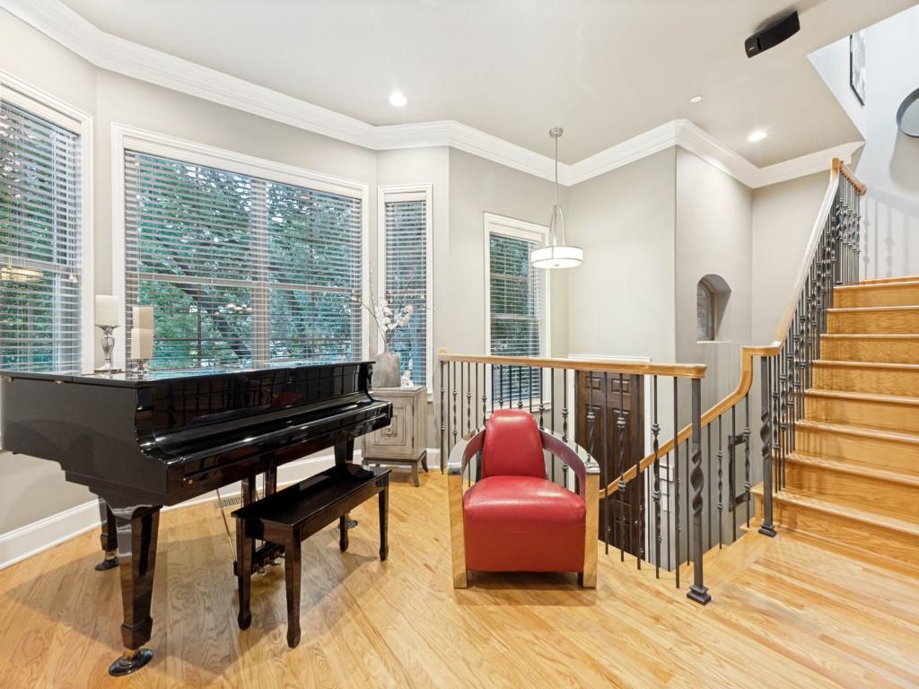 The Gem of Georgetown Courts Townhomes! This Magnificently Updated timeless Brownstone is Gated and Lock and Leave! Quality Enhanced Updates throughout this property. Onetime owners who have renovated this 3-2-2 into a designer's masterpiece. This move-in ready home features new hardwood floors, crown molding, and tall ceilings that create a warm, polished atmosphere filled with an abundance of natural light. The Modern kitchen offers quartz counters, stainless steel appliances, a gas range, and bar seating that flows into an open living and dining area with fireplace which is perfect for hosting friends or relaxing at home. Also, a renovated Powder bath off the kitchen. Surround sound enhances the experience, whether you're entertaining guests or enjoying a quiet night. Upstairs the spacious primary suite includes a custom walk-in closet, renovated primary bathroom with dual sinks, claw bathtub, and separate shower. Also, a wonderful Rooftop deck is off the Primary. The renovated utility room with stacked washer and dryer and sink and many built-in cabinets. Also located on the second level are two large bedrooms with large walk in closets and a wonderfully renovated shared bathroom. The charming and tranquil den on the second floor is such a great place to chill.  This is one of the few properties in Georgetown Court Townhomes with 3 bedrooms. HOA covers water, landscaping, insurance, and the roof was replaced in 2020. This home is near the beautiful Exall Park, Baylor Medical Center, and just minutes from Uptown, Downtown, Knox Henderson, Deep Ellum, Klyde Warren Park, and the Dallas Arts District. Many more amenities.