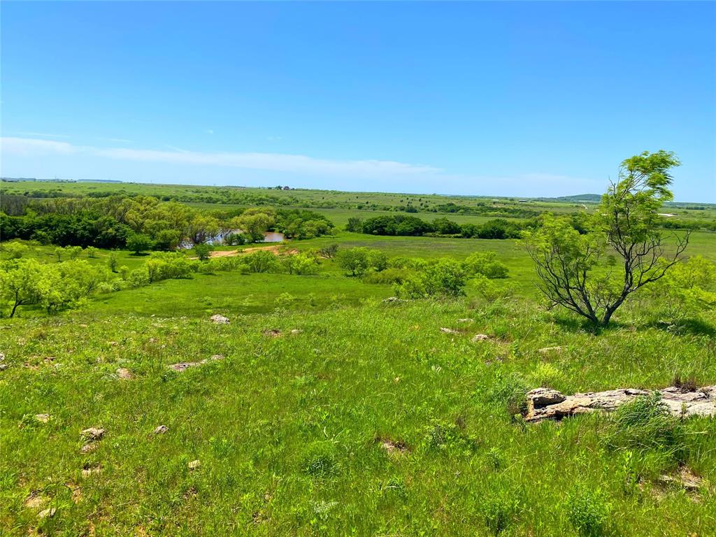 275 Acres – Rolling with over 80' of elevation change. Creek running through the property with 4 stock ponds, excellent hunting & recreational property, good native grass for grazing and wonderful building sites with long views. Located just minutes from town with city water and has highway and county road frontage.