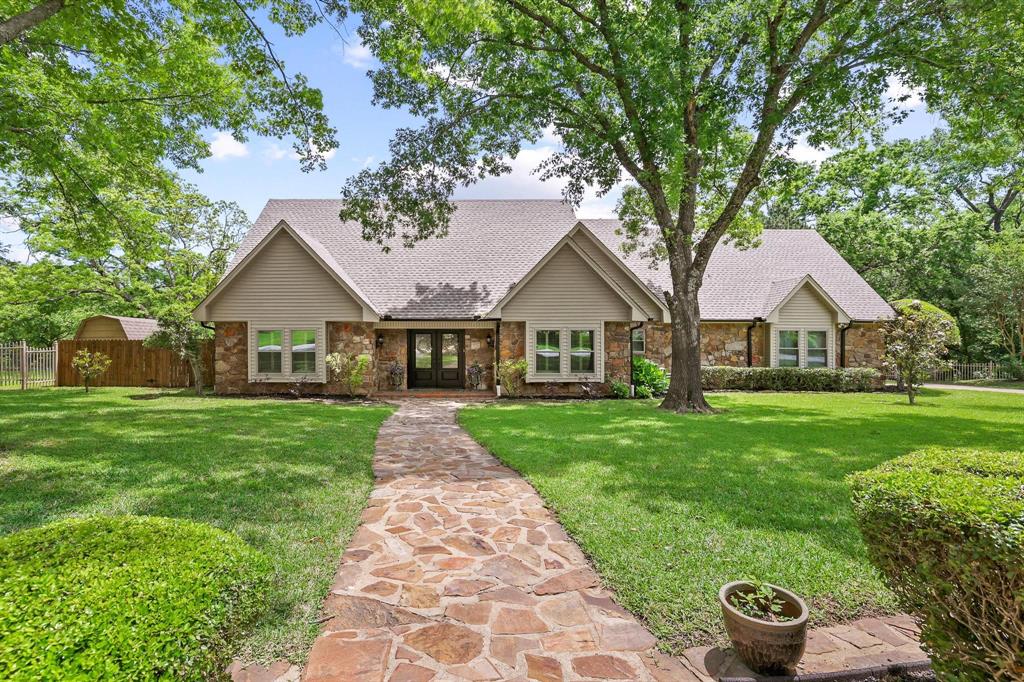 Beautifully maintained home on a spacious, tree-filled lot in Denison! This charming property features a striking stone exterior, excellent curb appeal, and a welcoming front entry. The backyard is designed for entertaining with a sparkling in-ground pool, expansive stone patio, and a large covered upper-level deck overlooking the private yard. The home offers a functional layout with generous living spaces and abundant natural light. Outdoor features include mature trees, full fencing, and a versatile storage building. The impressive stone fireplace and chimney adds character and warmth to the home’s design. Located in an established neighborhood with a peaceful setting, this property combines comfort, style, and exceptional outdoor living. A must-see!