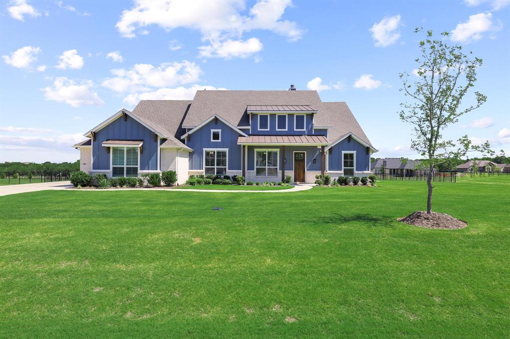 Situated on a one-acre lot in highly sought-after Gunter ISD, this thoughtfully upgraded single-story home offers 4 bedrooms, 3 full baths, a dedicated office, and a spacious media or game room that could easily serve as a 5th bedroom. Every bedroom and flex space features its own walk-in closet, including the office and media room. The open-concept layout is designed for both everyday living and entertaining, featuring a spacious living room with a floor-to-ceiling stone wood-burning fireplace and a beautifully appointed kitchen with an oversized island, double ovens, abundant cabinetry, and an electric cooktop with an existing gas line available for future propane conversion. The private primary suite offers dual vanities, a soaking tub, oversized walk-in shower, linen closet, and large walk-in closet. Thoughtful upgrades throughout the home include plantation shutters, electric shades in the living room, upgraded high-end carpet added after closing, and soft-close cabinets and drawers throughout. The oversized laundry room features decorative tile flooring, a sink, folding counter, and extensive cabinetry. The oversized garage includes epoxy flooring, overhead storage racks, insulated walls and garage door, plus additional outlets including a dedicated refrigerator outlet. Additional insulation between the game room and dining room, as well as between the living room and primary suite, enhances comfort and sound control. Outside, enjoy both a covered front porch and a spacious covered back patio overlooking the large wrought iron fenced backyard, along with an extra-wide and extra-long driveway offering ample parking space. Combining luxury finishes, functional design, and peaceful country living, this beautifully maintained home is ready for its next owner.