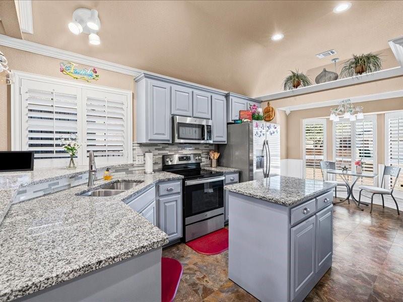 Imagine leaving your driveway in your golf cart and arriving at Harbor Lakes Country Club just minutes later. Welcome to one of Granbury's most desirable low-maintenance lifestyles! Nestled on a quiet horseshoe street of approximately 20 townhomes, this spacious 2-bedroom, 2-bath home offers comfort and an easy lock-and-leave lifestyle in an established 55+ community.

Step through the gated courtyard into a light-filled home featuring soaring vaulted ceilings, plantation shutters, crown molding, and a wood-burning fireplace. Large windows fill the living spaces with natural light and overlook the private patio and green space.

The open-concept kitchen features granite countertops, abundant cabinetry, pantry storage, breakfast bar seating, a built-in china hutch, and a movable granite-topped island with additional storage.

The enclosed sunroom opens to both a private side patio and a spacious rear patio overlooking green space—perfect for relaxing or entertaining.

The oversized primary suite offers room for a sitting area, home office, or exercise space. The ensuite bath includes dual vanities, a separate tub and shower, elevated toilet, a large walk-in closet with shelving, plus a second closet.

Additional features include a formal dining room, breakfast area, six ceiling fans, generous storage, wider doorways, and an oversized attached garage with a utility sink. Flexible garage space accommodates two vehicles plus a golf cart, depending on vehicle size and parking arrangement.

The $90 monthly HOA includes lawn mowing, edging, and irrigation, giving you more time to enjoy Historic Granbury Square, Lake Granbury, shopping, restaurants, and medical facilities.

Property is vacant and ready for immediate occupancy. Some photos reflect the home when previously furnished to illustrate room size and furniture placement. Owner is a licensed Texas real estate agent.