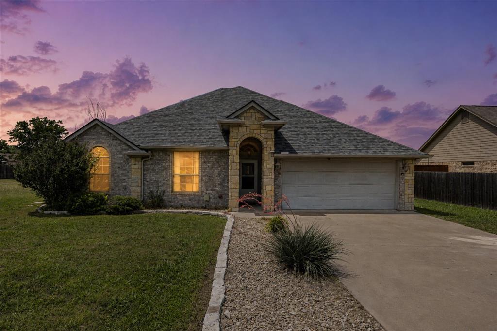 Motivated sellers are offering this well-maintained all-brick home offering a spacious split-bedroom floor plan and a fantastic west Granbury location with no HOA and outside the city limits. 

The open-concept living area is anchored by a beautiful rock fireplace and flows seamlessly into the kitchen, featuring granite countertops, ample cabinetry, and a cozy breakfast area. A separate formal dining room provides additional space for entertaining and family gatherings.

The generously sized primary suite serves as a private retreat with an ensuite bath featuring dual amenities, a separate tub and shower, and a large walk-in closet. Two additional bedrooms offer flexibility for family, guests, or a home office.

Step outside to enjoy the covered back patio overlooking a neighboring pasture, where you'll often find horses grazing and playing, creating a peaceful country feel while still being close to town. The oversized, fully fenced backyard offers endless possibilities with plenty of room for a workshop, RV parking, additional storage, or even a future swimming pool. Conveniently located to nearby shopping and amenities and a 3 minute drive to Granbury Medical Center.

Whether you're looking for a primary residence or an investment opportunity, this property offers versatility and value. Previously utilized as a rental property, it has proven income potential while also providing all the features needed for comfortable everyday living. Vacant and ready for immediate showings.