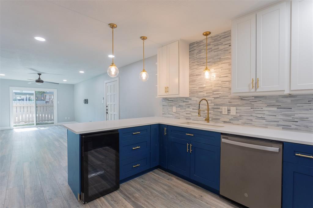 Welcome to easy, stylish living in this beautifully updated 2-bedroom, 2-bathroom first-floor condo, perfectly positioned poolside with a private patio and small grassy area. Step inside to an open, light-filled layout featuring durable luxury vinyl plank flooring throughout, designer paint, modern lighting, and upgraded baseboards throughout. The custom kitchen is a true standout, showcasing quartz countertops, sleek slate appliances, dual tone cabinets, a breakfast bar, and a built-in wine cooler—perfect for everyday living and hosting alike. Both bathrooms have been fully renovated with stylish tile work and contemporary vanities, while updated doors—including eye-catching barn doors—add a unique and modern touch. New windows and a sliding glass door bring in abundant natural light and provide seamless access to your outdoor space with tranquil pool views. Enjoy the convenience of a built-in laundry area with a stackable washer and dryer. Washer, dryer, refrigerator and wine fridge all convey! One covered parking space adds extra ease. Located just minutes from shopping, dining, Highway 75, and entertainment, this move-in-ready condo offers the perfect blend of comfort, style, and location.