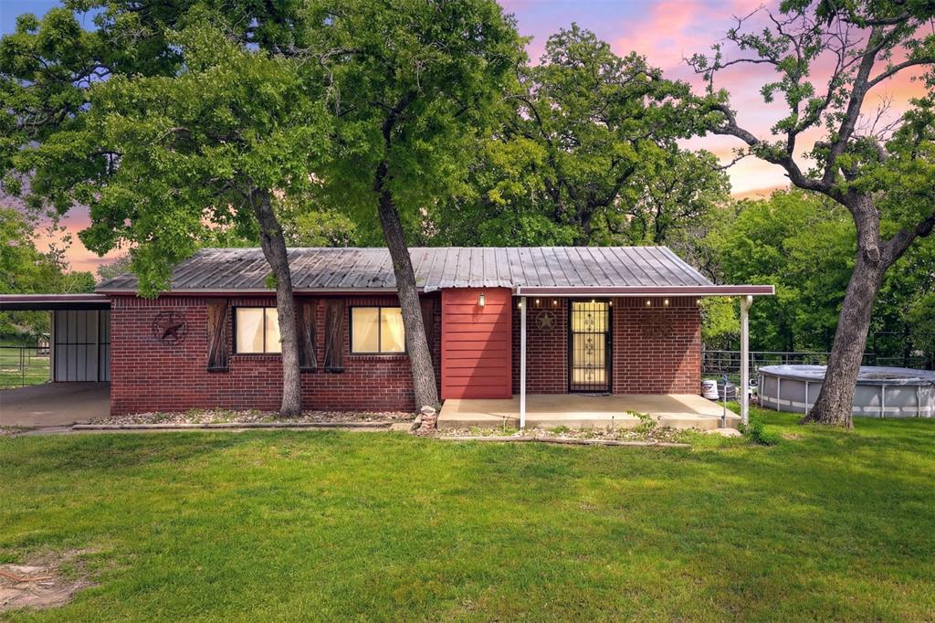 Priced to sell! Bring all offers! The perfect blend of functionality and country living on this 11.7 acre fully fenced property designed for both comfort and versatility. This fully bricked doublewide with an added living space offers two spacious living areas, ideal for entertaining or relaxing. Refrigerator, washer and dryer stay with home. Recent updates include a new AC system installed in 2024 and a durable metal roof for long-term peace of mind. Gated entrance that is well-equipped for livestock, or hobbies. The front is secured with pipe fencing, while the remainder is fully fenced and cross-fenced for optimal land use. HORSES welcomed. Includes a 5 stall barn with electric and water, two pipe runs with loafing sheds, a metal feed shed, pasture area, and a partial arena located toward the back of the property. A seasonal creek adds to the natural appeal. For additional workspace and storage, you’ll find a 22x40 metal shop complete with electric, water, and a concrete slab, along with an oversized carport and dedicated RV parking. Enjoy privacy, wide-open space, and the flexibility to make this property your own—all while having the infrastructure already in place.